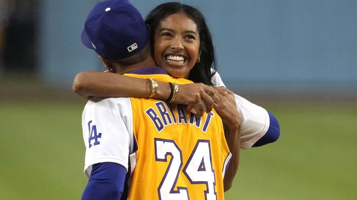 Natalia Bryant, daughter of Kobe Bryant, hugs Los Angeles Dodgers' Mookie Betts after throwing out the ceremonial first pitch prior to a baseball game between the Dodgers and the Atlanta Braves Friday, Sept. 1, 2023, in Los Angeles.