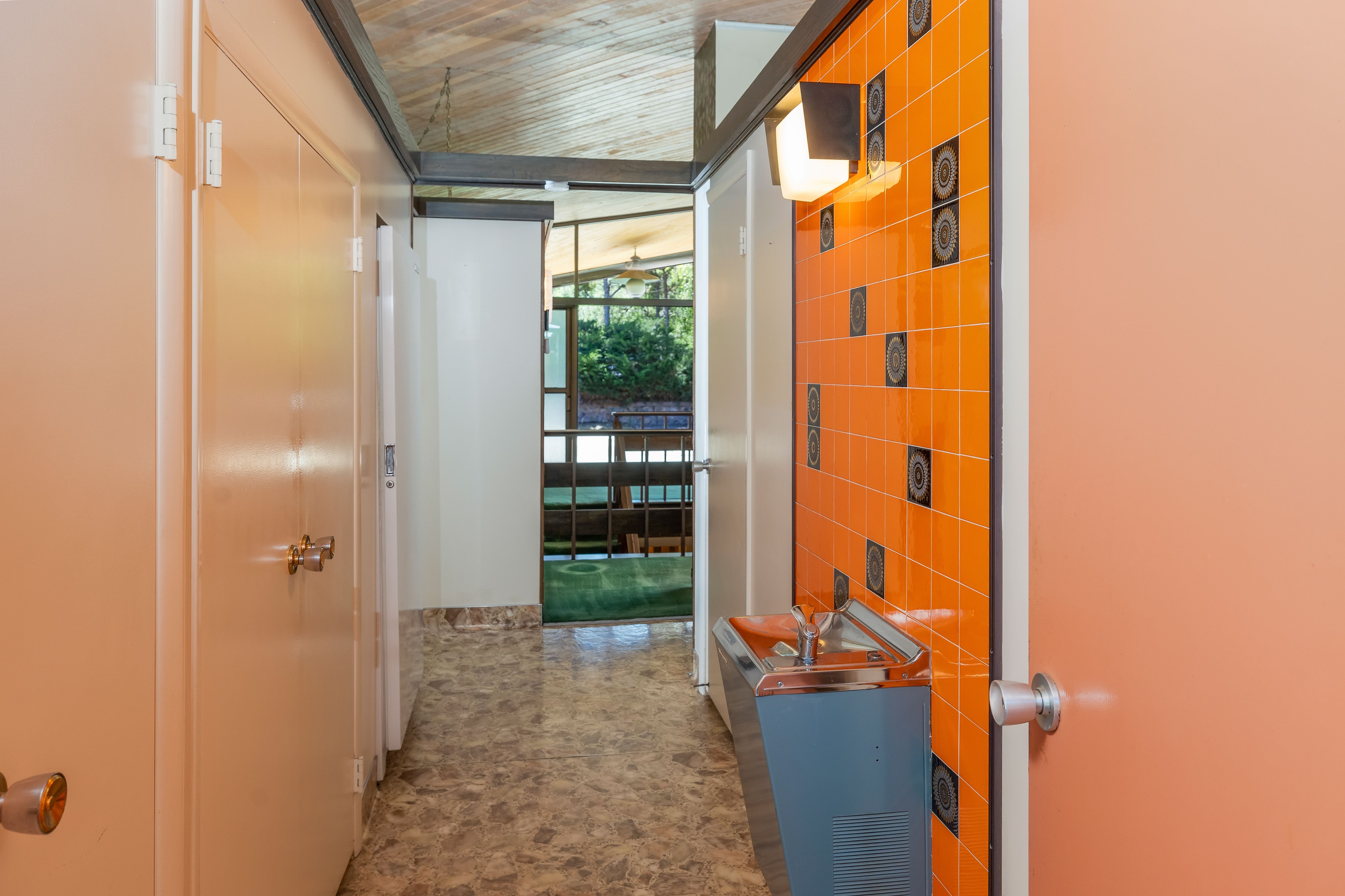 A drinking fountain is installed in the hallway of this midcentury modern house for sale in Providence, Cache County, Utah.
