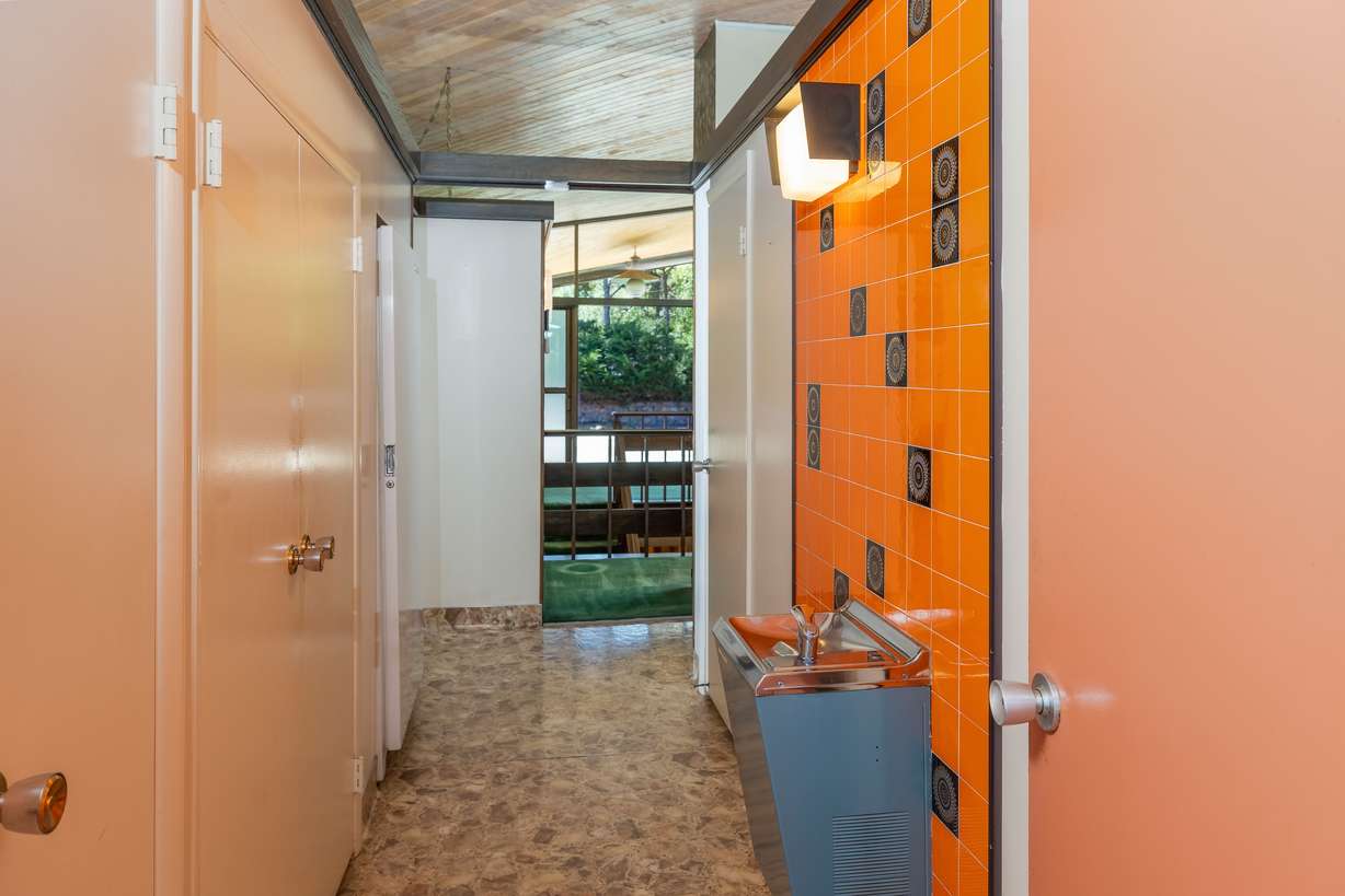 A drinking fountain is installed in the hallway of this midcentury modern house for sale in Providence, Cache County, Utah.