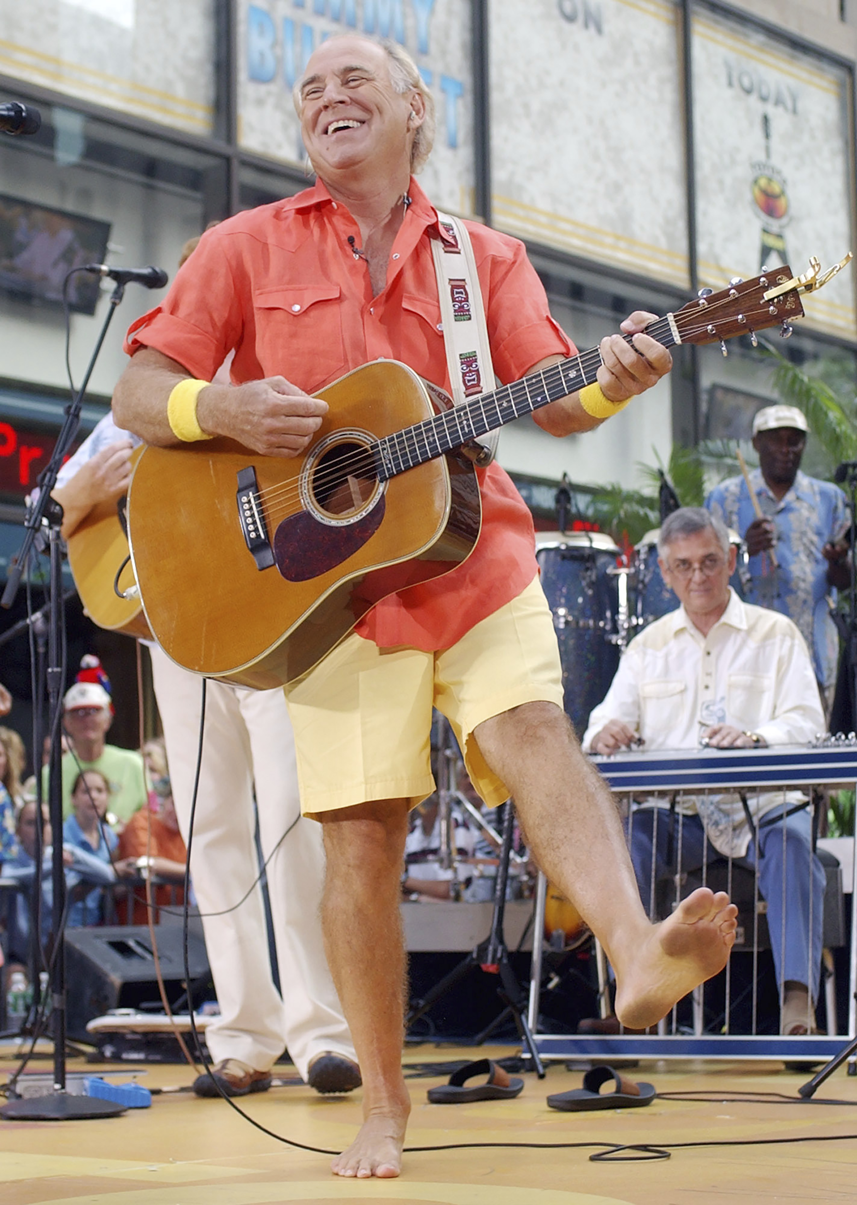 Singer Jimmy Buffet performs barefooted with his band The Coral Reefers on the NBC "Today" television show summer concert series in New York's Rockefeller Plaza, on June 25, 2004. “Margaritaville” singer-songwriter Jimmy Buffett has died at age 76. A statement on Buffett's official website and social media pages says the singer died Friday, “surrounded by his family, friends, music and dogs”.