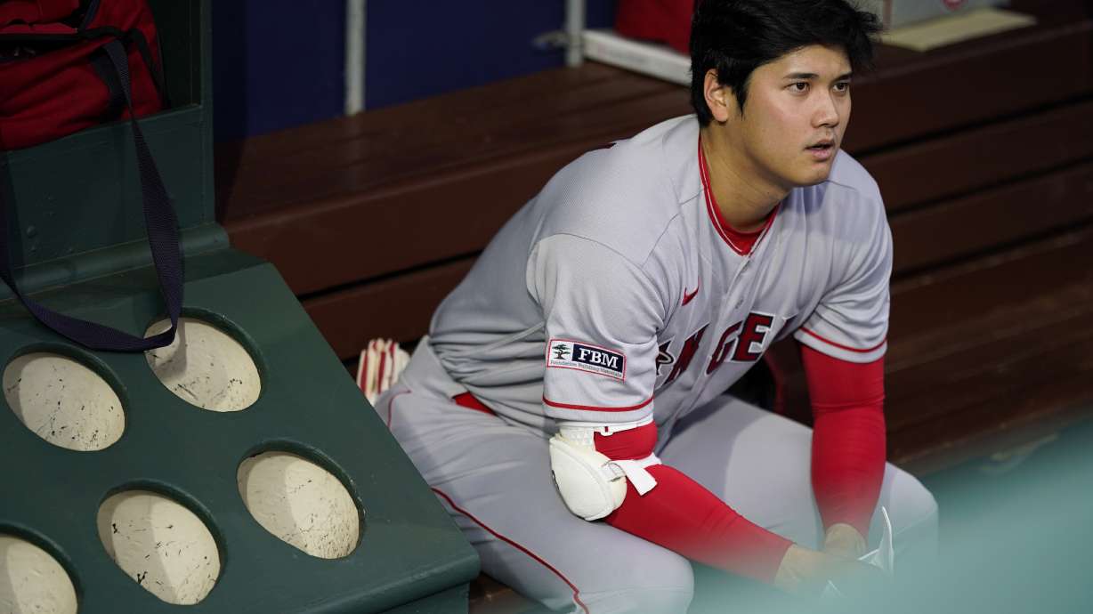 Los Angeles Angels' Shohei Ohtani sits in the dugout before a baseball game against the Philadelphia Phillies, Tuesday, Aug. 29, 2023, in Philadelphia.