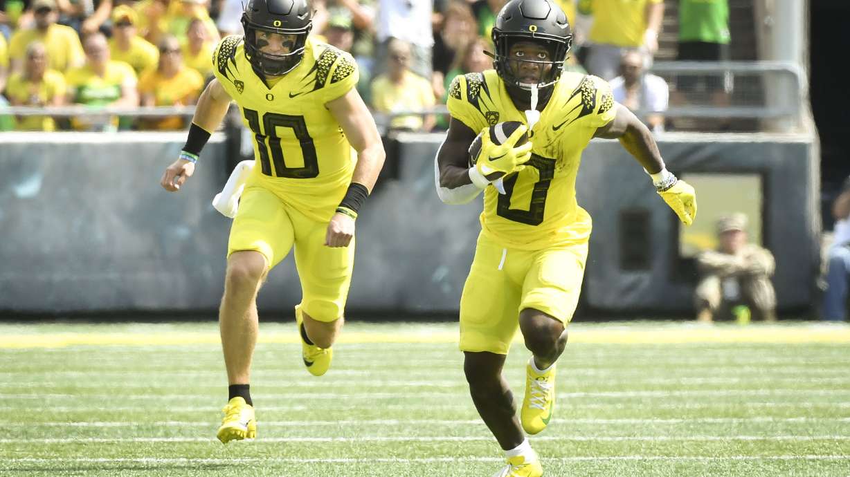 Oregon running back Bucky Irving (0) heads to the end zone trailed by quarterback Bo Nix (10) to score against Portland State during the first half of an NCAA college football game Saturday, Sept. 2, 2023, in Eugene, Ore.