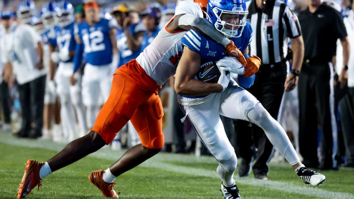 Sam Houston Bearkats defensive back Donovan Adkins (12) tackles BYU Cougars wide receiver Chase Roberts (2) during the game at LaVell Edwards Stadium in Provo on Saturday, Sept. 2, 2023.