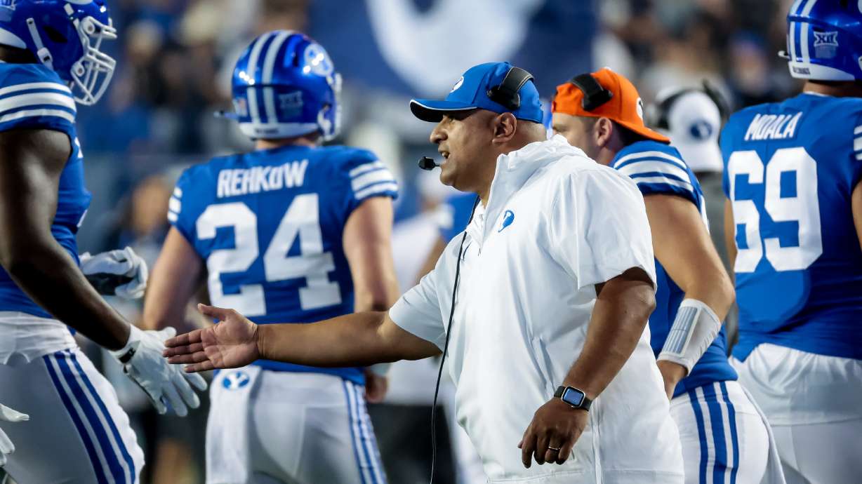BYU Cougars head coach Kalani Sitake celebrates with players after a touchdown during the game against the Sam Houston Bearkats at LaVell Edwards Stadium in Provo on Saturday, Sept. 2, 2023.