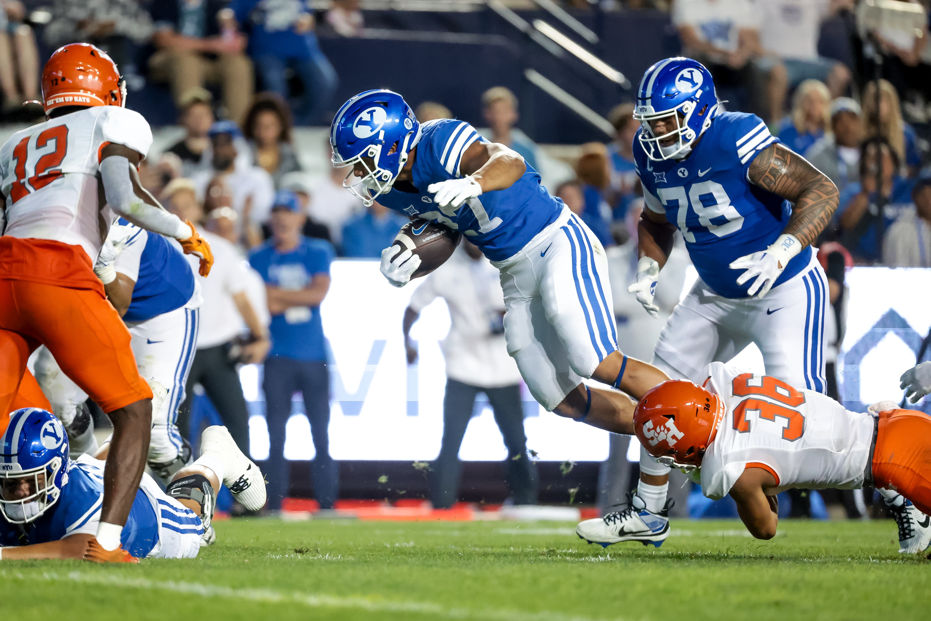 BYU Cougars running back LJ Martin (27) is tackled by Sam Houston Bearkats defensive back Elias Escobar (36) during the game at LaVell Edwards Stadium in Provo on Saturday, Sept. 2, 2023.