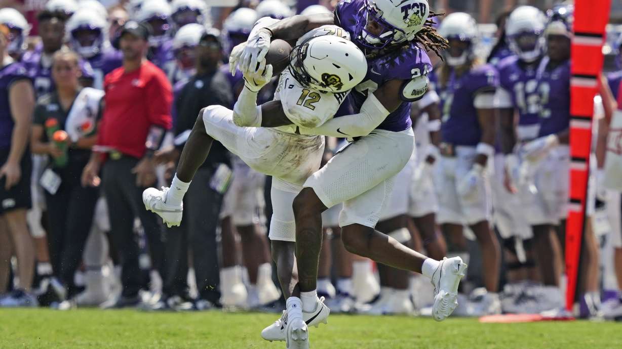 Colorado cornerback Travis Hunter (12) catches a pass for a first down against TCU cornerback Avery Helm (24) during the second half of an NCAA college football game Saturday, Sept. 2, 2023, in Fort Worth, Texas.