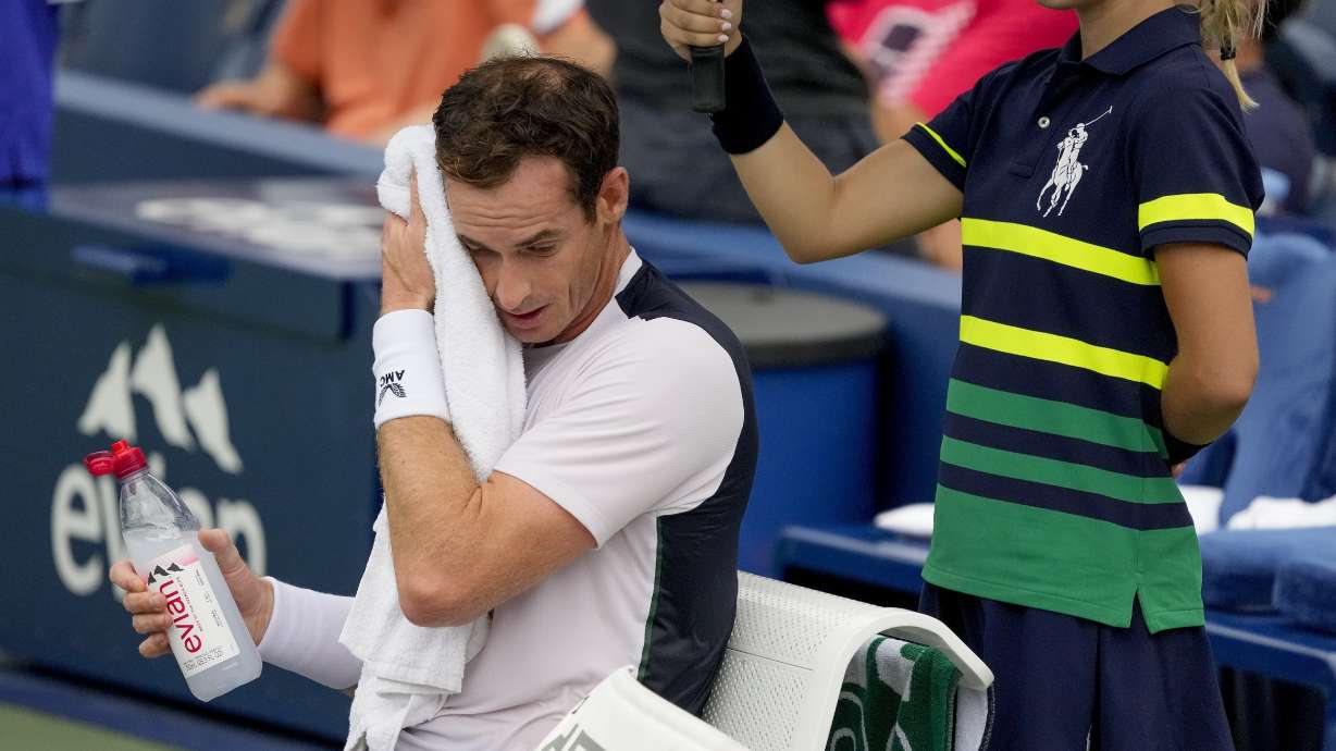 FILE - Andy Murray, of Britain, wipes sweat from his brow during a break in play against Corentin, Moutet, of France, during the first round of the U.S. Open tennis championships, Tuesday, Aug. 29, 2023, in New York. An Associated Press analysis shows the average high temperatures during the U.S. Open and the three other Grand Slam tennis tournaments steadily have grown hotter and more dangerous in recent decades.