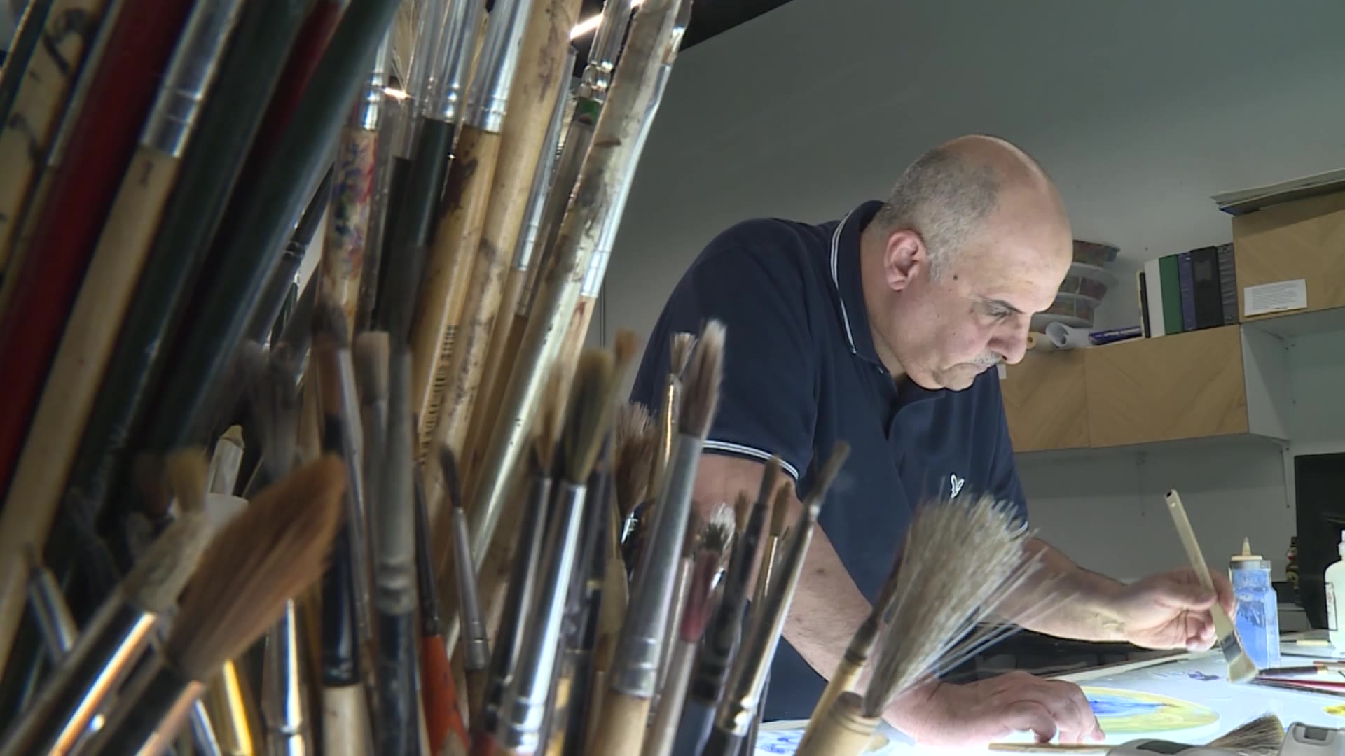 Ali Albaddah working on the mixture of Arabic calligraphy and stained glass art in Lehi. He is joining artists from Holdman Studios in Lehi to create a one-of-its-kind Sphere of Light – a building of stained glass.