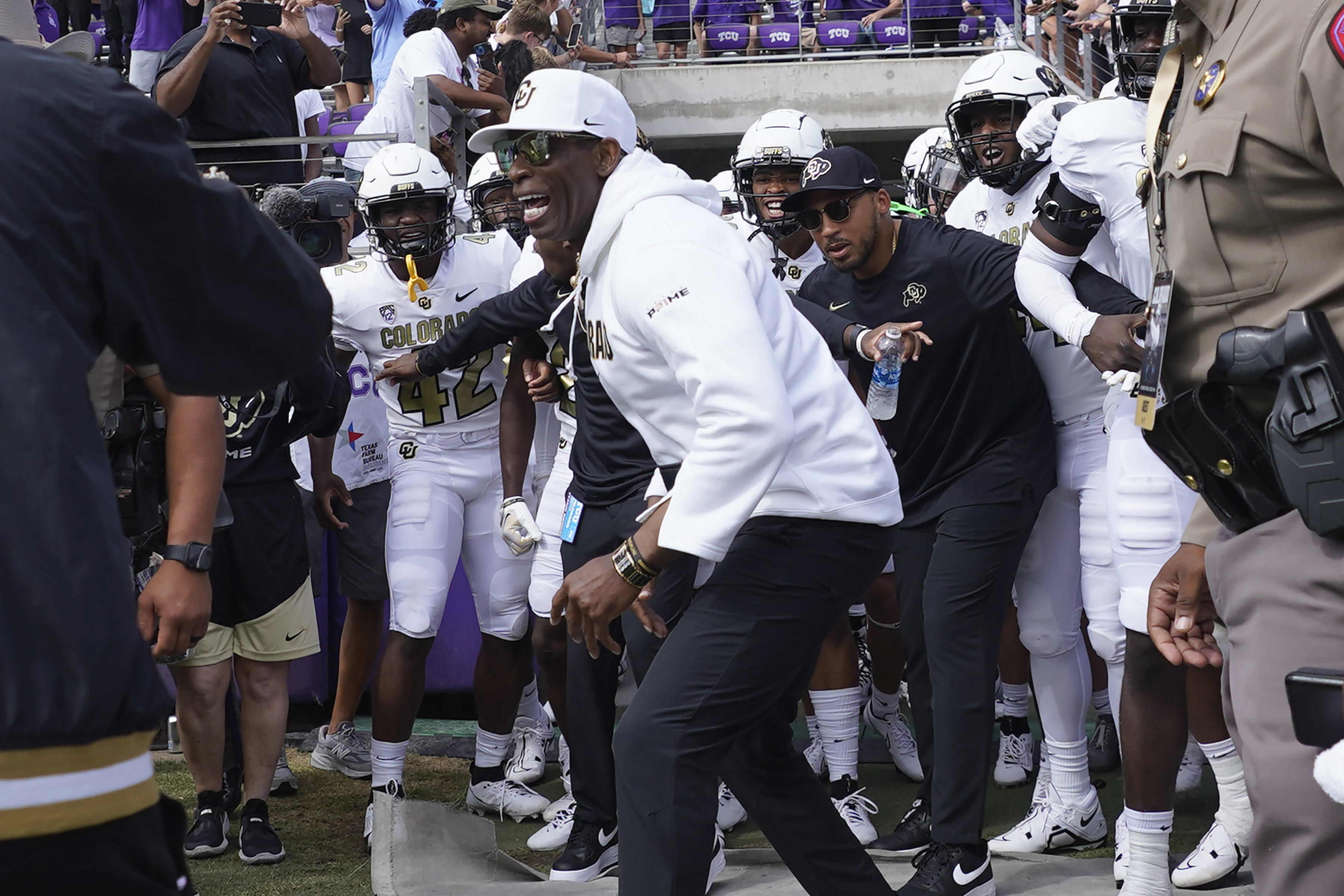 Colorado head coach Deion Sanders runs onto the field with his team for a an NCAA college football game against TCU Saturday, Sept. 2, 2023, in Fort Worth, Texas.