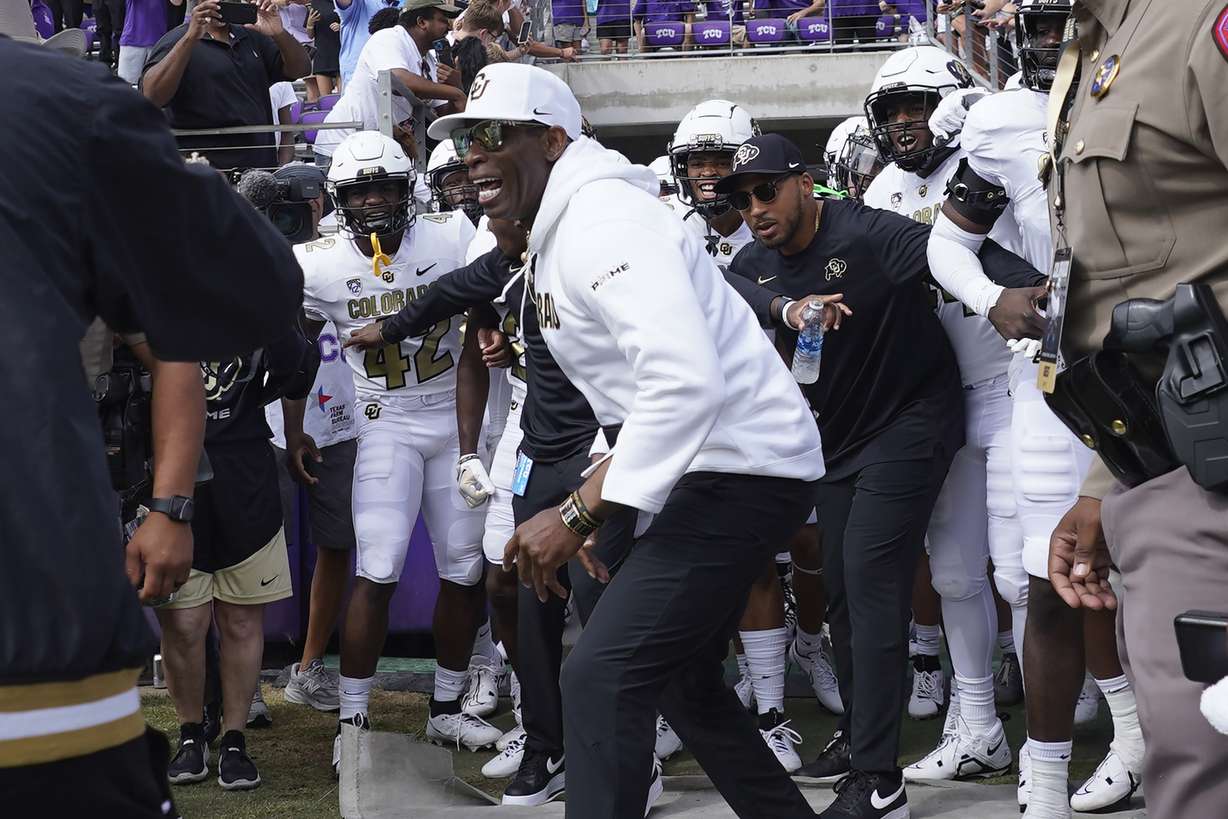 Colorado head coach Deion Sanders runs onto the field with his team for a an NCAA college football game against TCU Saturday, Sept. 2, 2023, in Fort Worth, Texas.