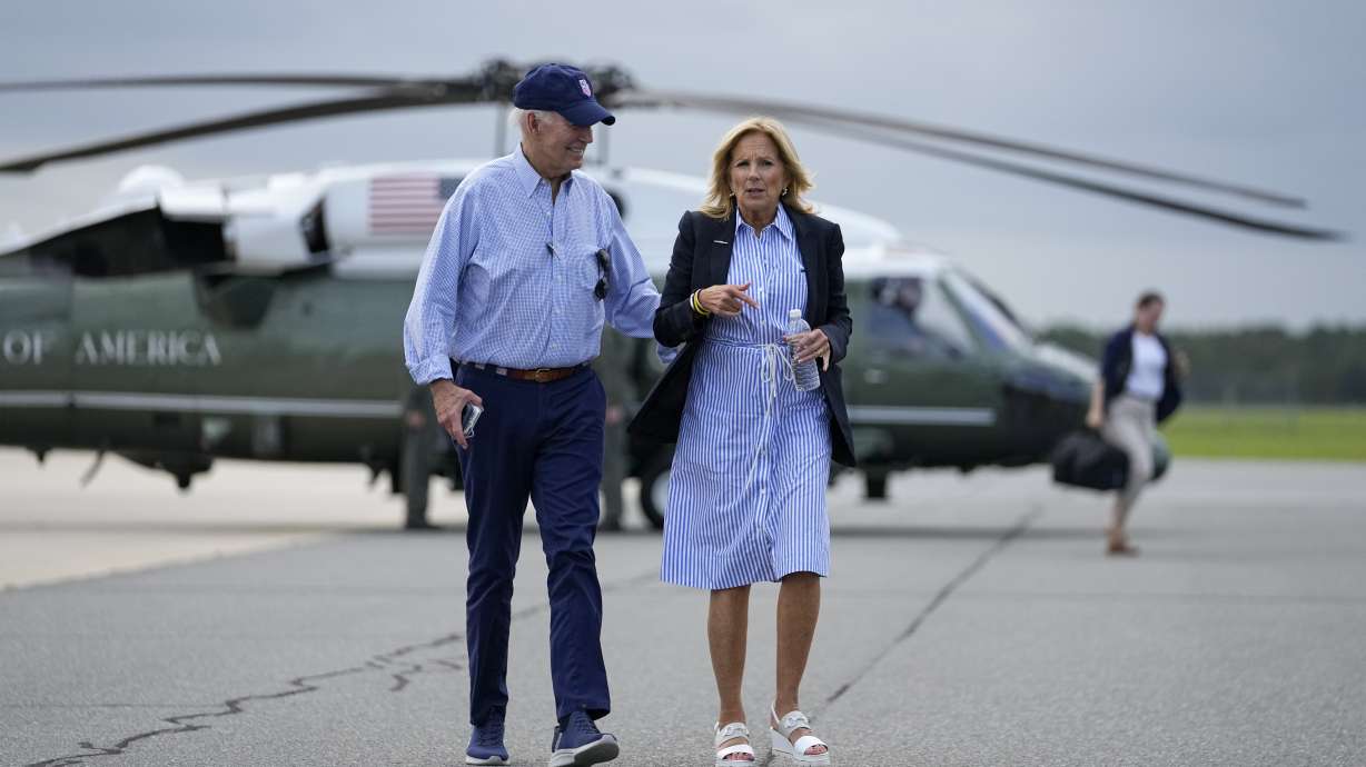 President Joe Biden and first lady Jill Biden walk to board Air Force One for departure Saturday, in Gainesville, Fla. First lady Jill Biden has tested positive for COVID-19.