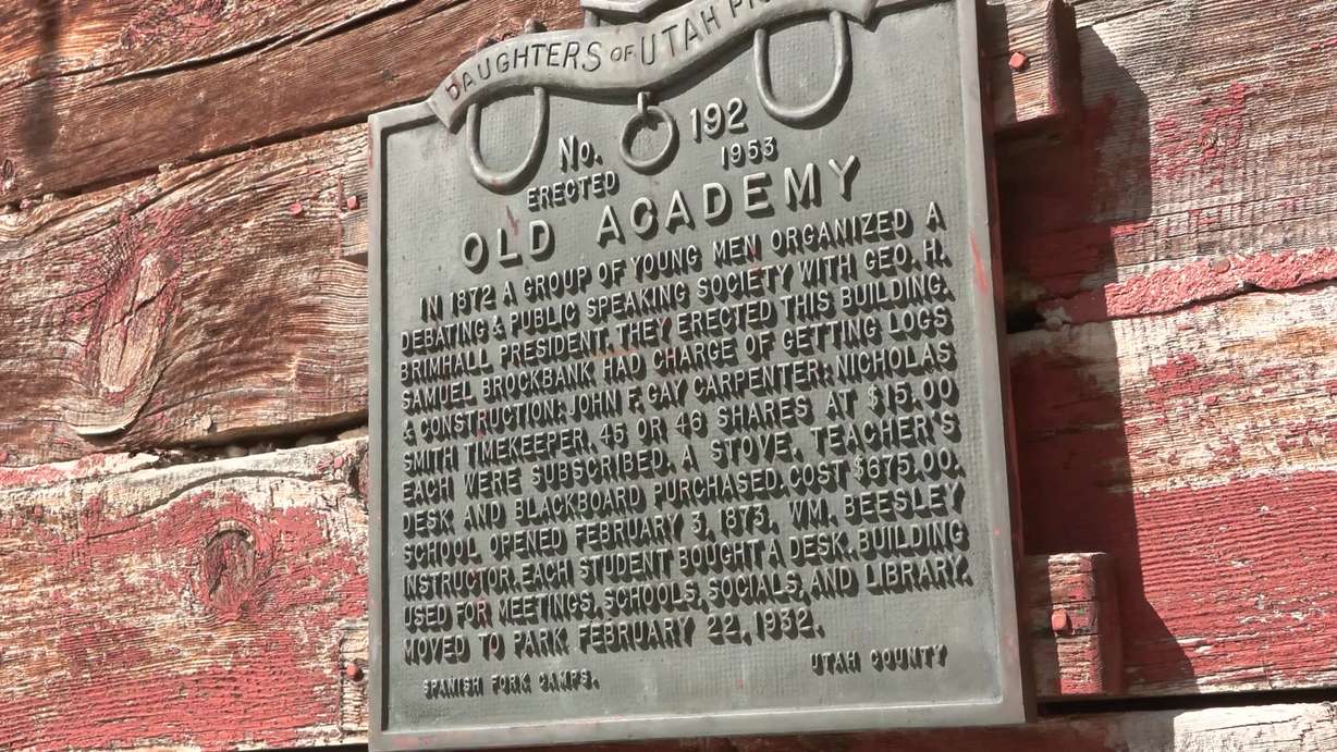 A plaque is shown outside the Spanish Fork historic schoolhouse. The Burton family purchased a home with the schoolhouse in the backyard and would like to open the schoolhouse to the community but need help restoring it.