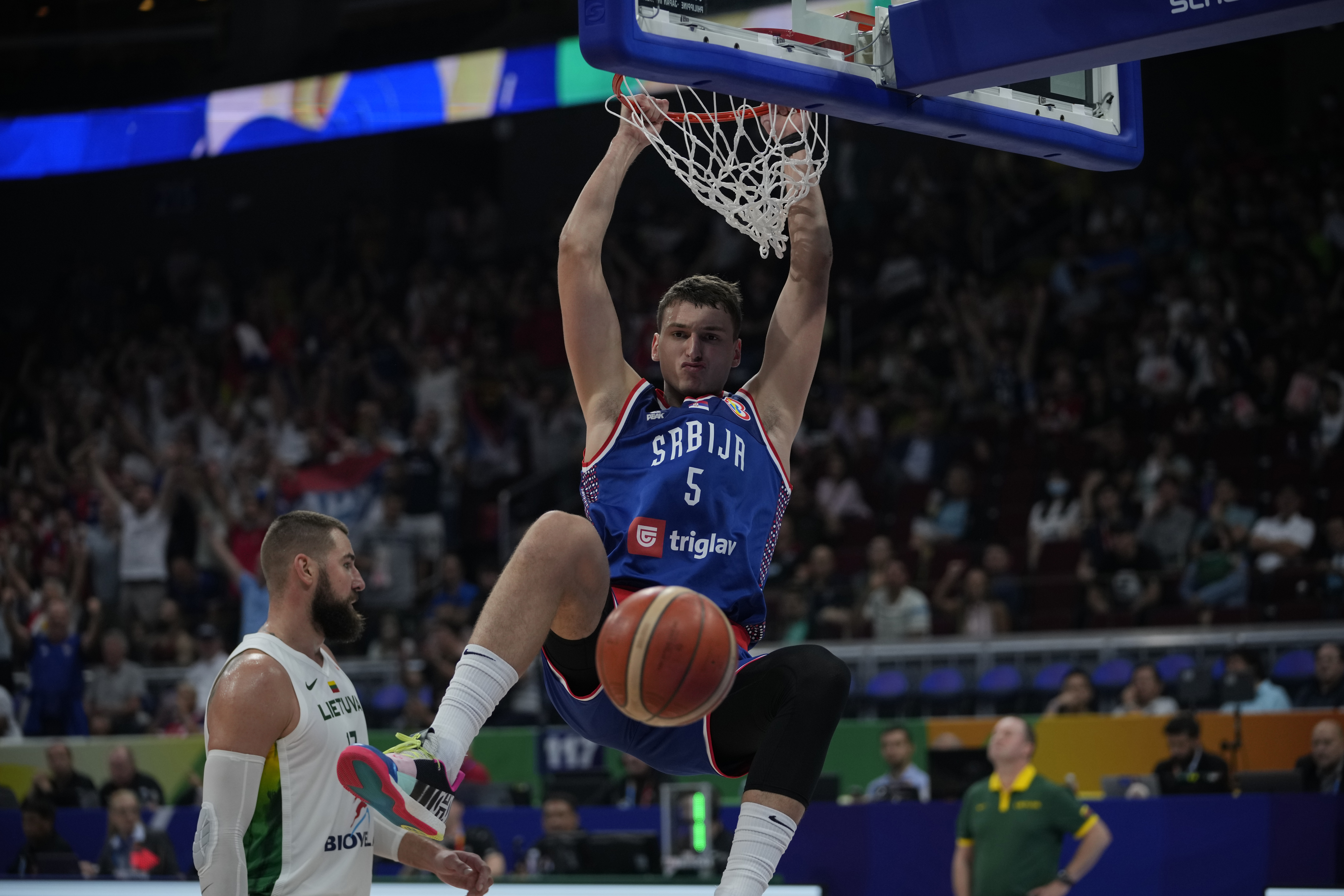 Serbia forward Nikola Jovic (5) dunks the ball during the Basketball World Cup quarterfinal game between Lithuania and Serbia at the Mall of Asia Arena in Manila, Philippines, Tuesday, Sept. 5, 2023. 