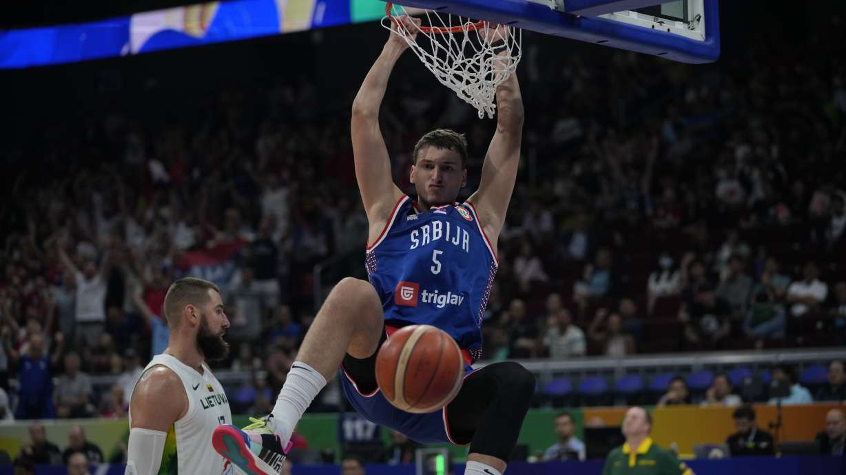 Serbia forward Nikola Jovic (5) dunks the ball during the Basketball World Cup quarterfinal game between Lithuania and Serbia at the Mall of Asia Arena in Manila, Philippines, Tuesday, Sept. 5, 2023.