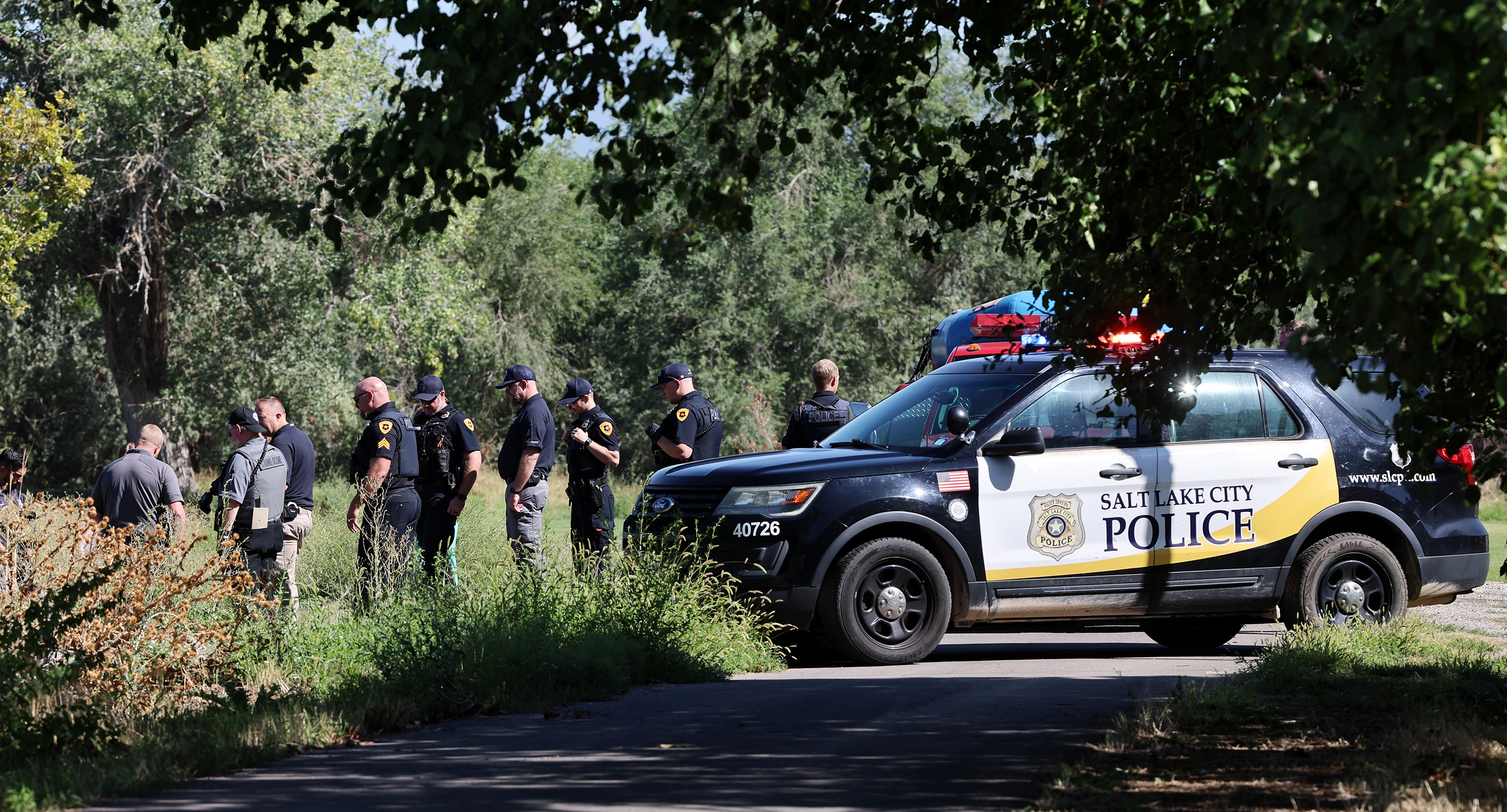 Authorities investigate at Rose Park Golf Course in Salt Lake City after a body was found in the Jordan River on Tuesday.