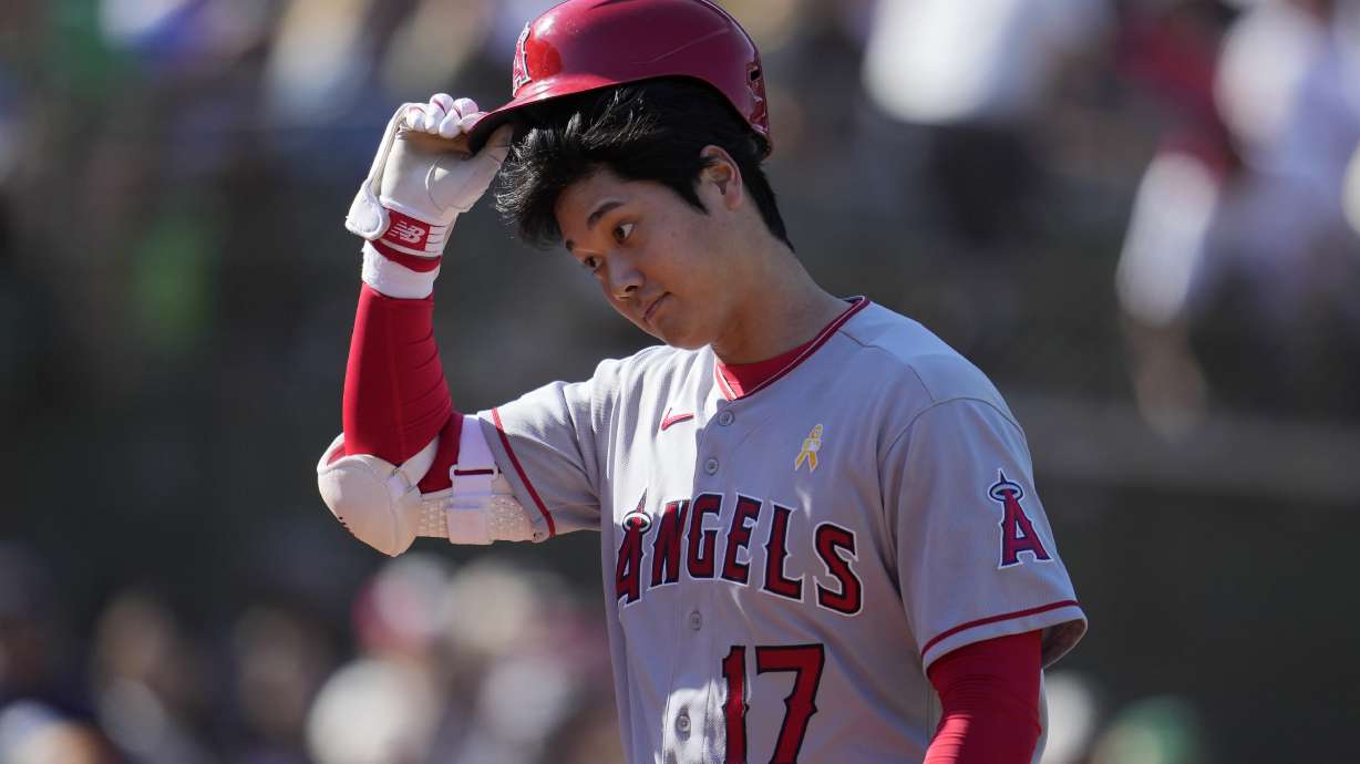 Los Angeles Angels' Shohei Ohtani walks to the dugout after striking out against the Oakland Athletics during the ninth inning of a baseball game in Oakland, Calif., Sunday, Sept. 3, 2023.
