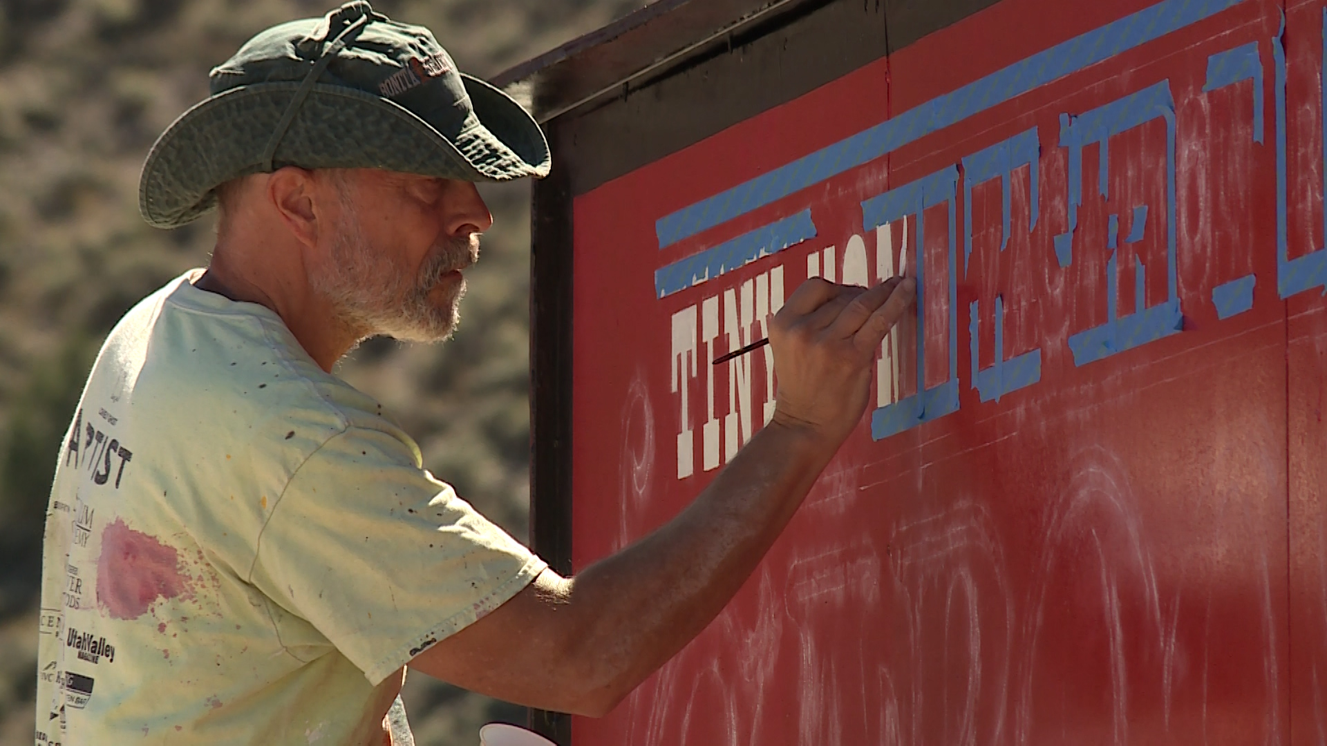 A staff worker repaints a sign in preparation for the Solar Eclipse event on Sept. 5.