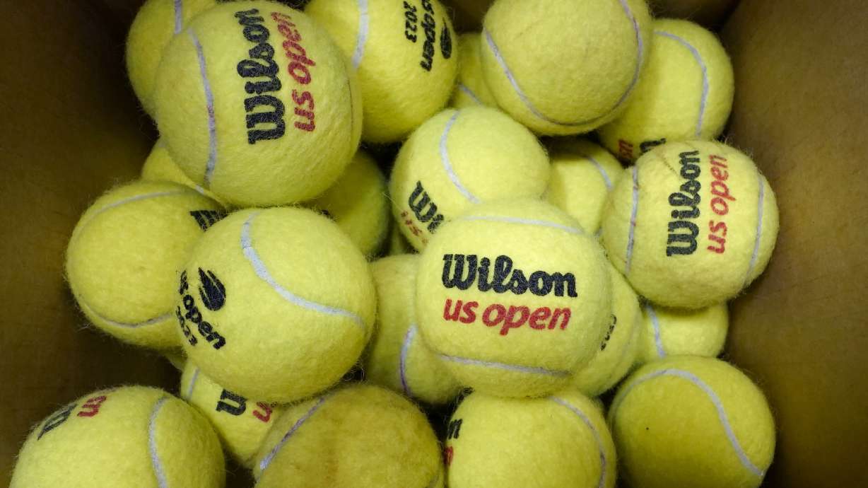 A box of game-used tennis balls rest in a shipping box during the U.S. Open tennis championships, Monday, Sept. 4, 2023, in New York. Because tennis balls are extremely hard to recycle and the industry has yet to develop a ball to make that easier, nearly all of the 330 million balls made worldwide each year eventually get chucked in the garbage, with most ending up in landfills.