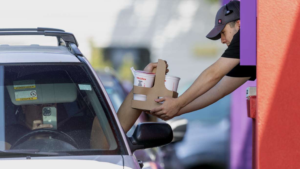 A Jack in the Box employee assists a customer in Salt Lake City June 27. The Salt Lake City Council voted Tuesday to ban new drive-thrus in the Sugar House Business District.