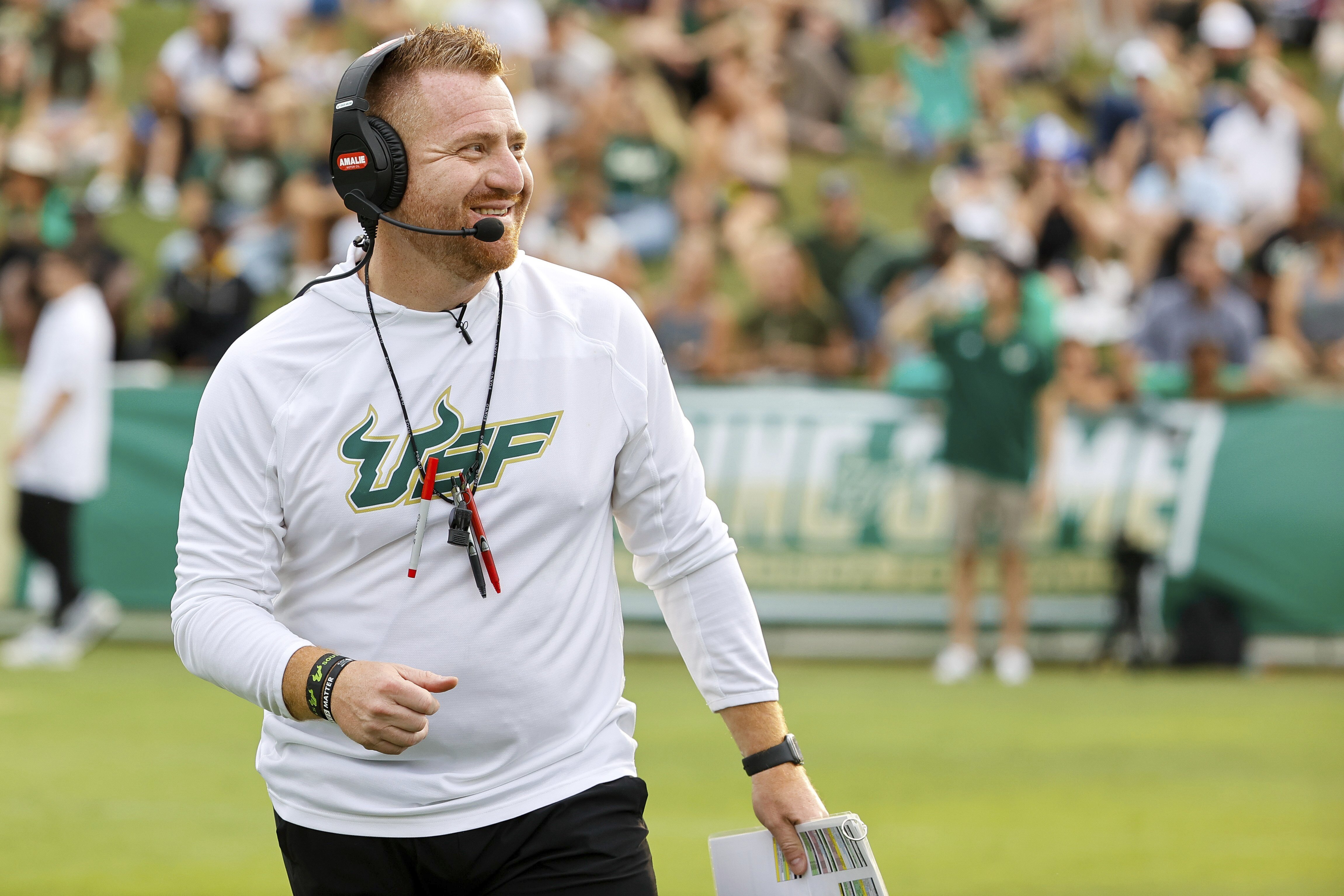 South Florida NCAA college football head coach Alex Golesh smiles during a spring scrimmage Friday, April 14, 2023, in Tampa, Fla. The University of South Florida is looking for some big changes when the Tampa school plans to open a new $340 million on-campus football stadium in 2026. The stadium is expected to seat about 35,000, far smaller than the 75,000 or so where the Bulls now play at Raymond James Stadium, home of the NFL's Tampa Bay Buccaneers.
