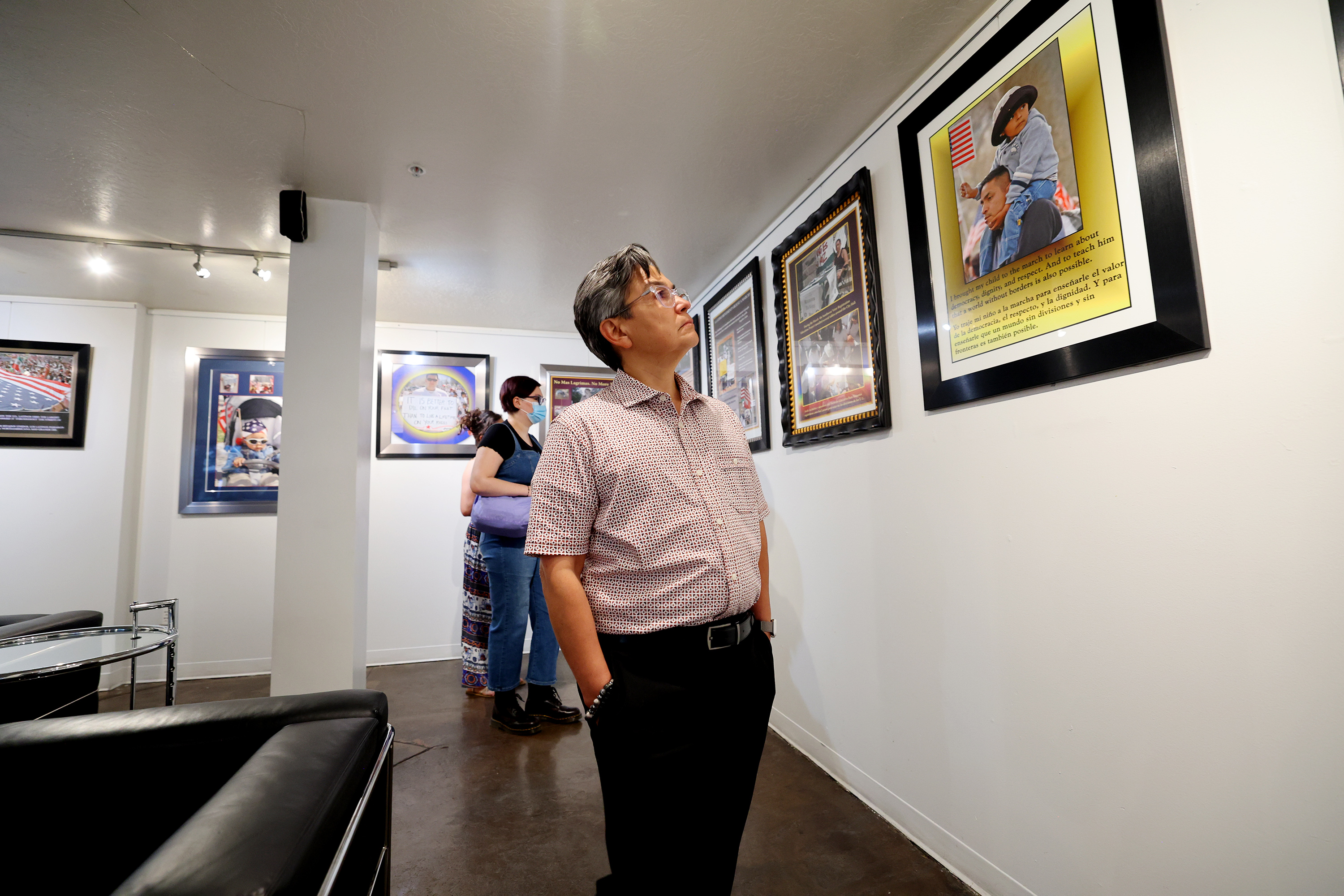 Mary Ann Villarreal looks at the work of Latino photographers on display at Mestizo Coffeehouse in Salt Lake City on Wednesday in commemoration of Hispanic Heritage Month. The photographs depict marches that took place in 2006.