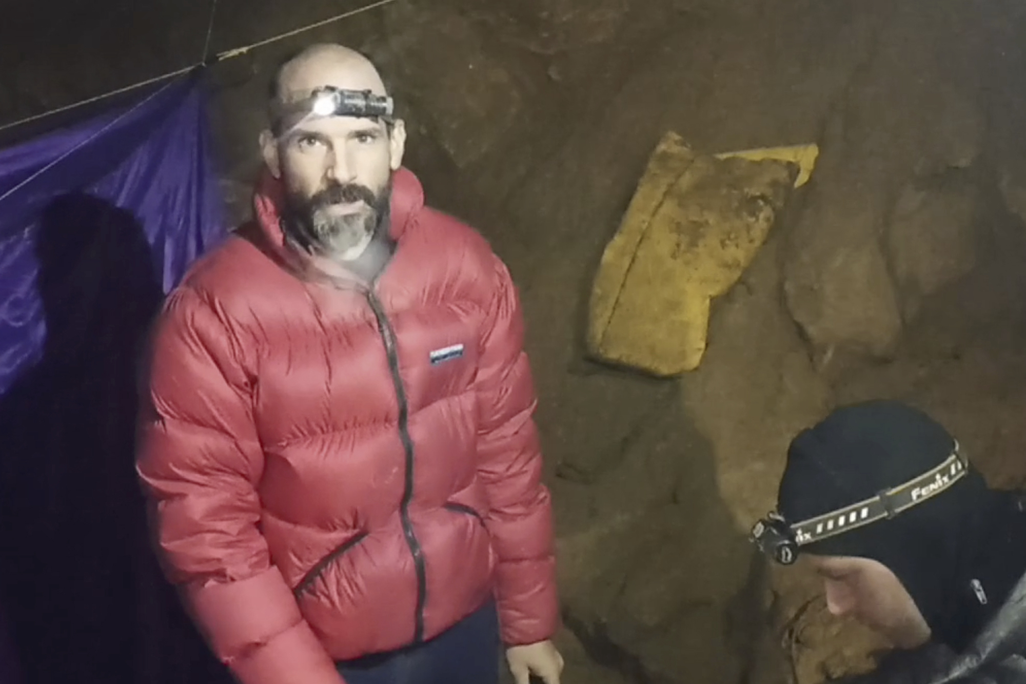 In this screen grab from video, American caver Mark Dickey, 40, talks to the camera next to a colleague inside the Morca cave near Anamur, southern Turkey, Thursday. Turkish and international cave rescue experts are working to save Dickey.