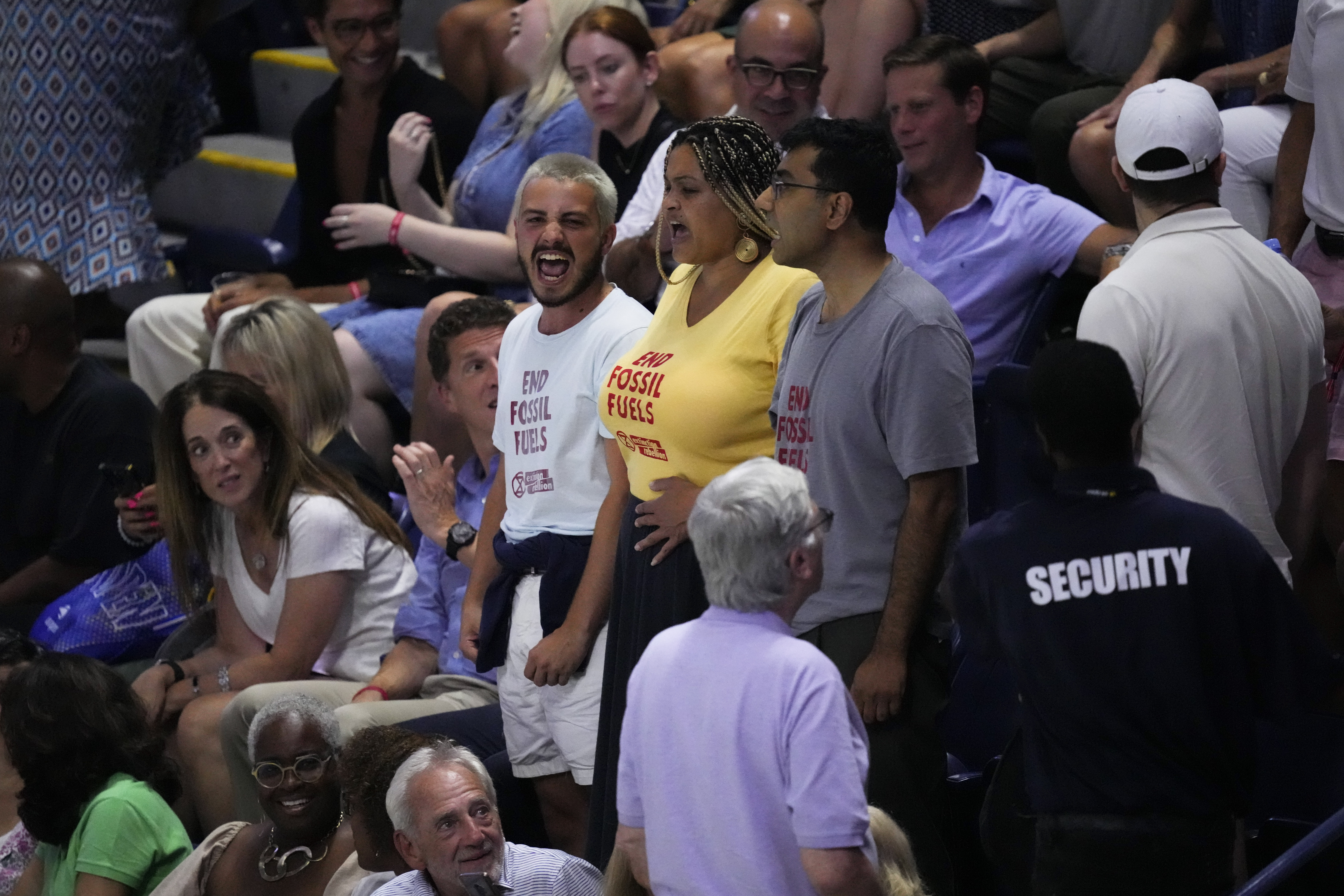 Protesters demonstrate at a match between Coco Gauff, of the United States, and Karolina Muchova, of the Czech Republic, during the women's singles semifinals of the U.S. Open tennis championships, Thursday, Sept. 7, 2023, in New York. 