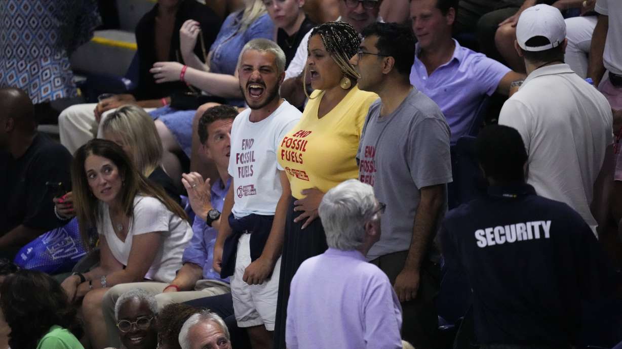 Protesters demonstrate at a match between Coco Gauff, of the United States, and Karolina Muchova, of the Czech Republic, during the women's singles semifinals of the U.S. Open tennis championships, Thursday, Sept. 7, 2023, in New York.