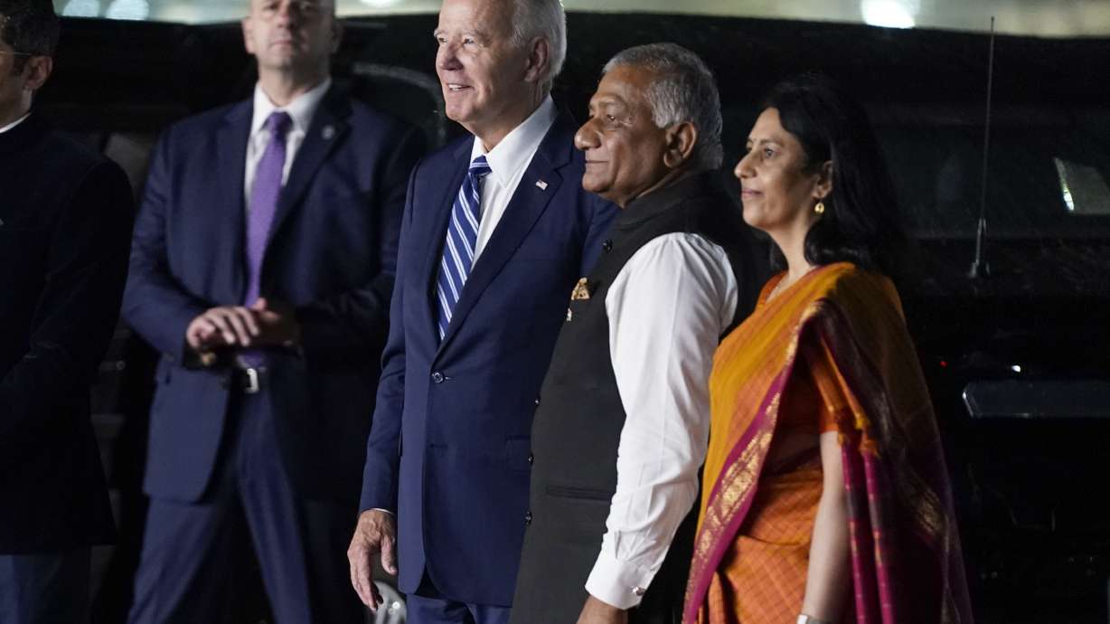 President Joe Biden watches dancers with Vani Sarraju Rao, Joint Secretary in the Ministry of External Affairs, right, and Vijay Kumar Singh, Minister of State for Road Transport, as he arrives in New Delhi to attend the G20 summit on Friday.