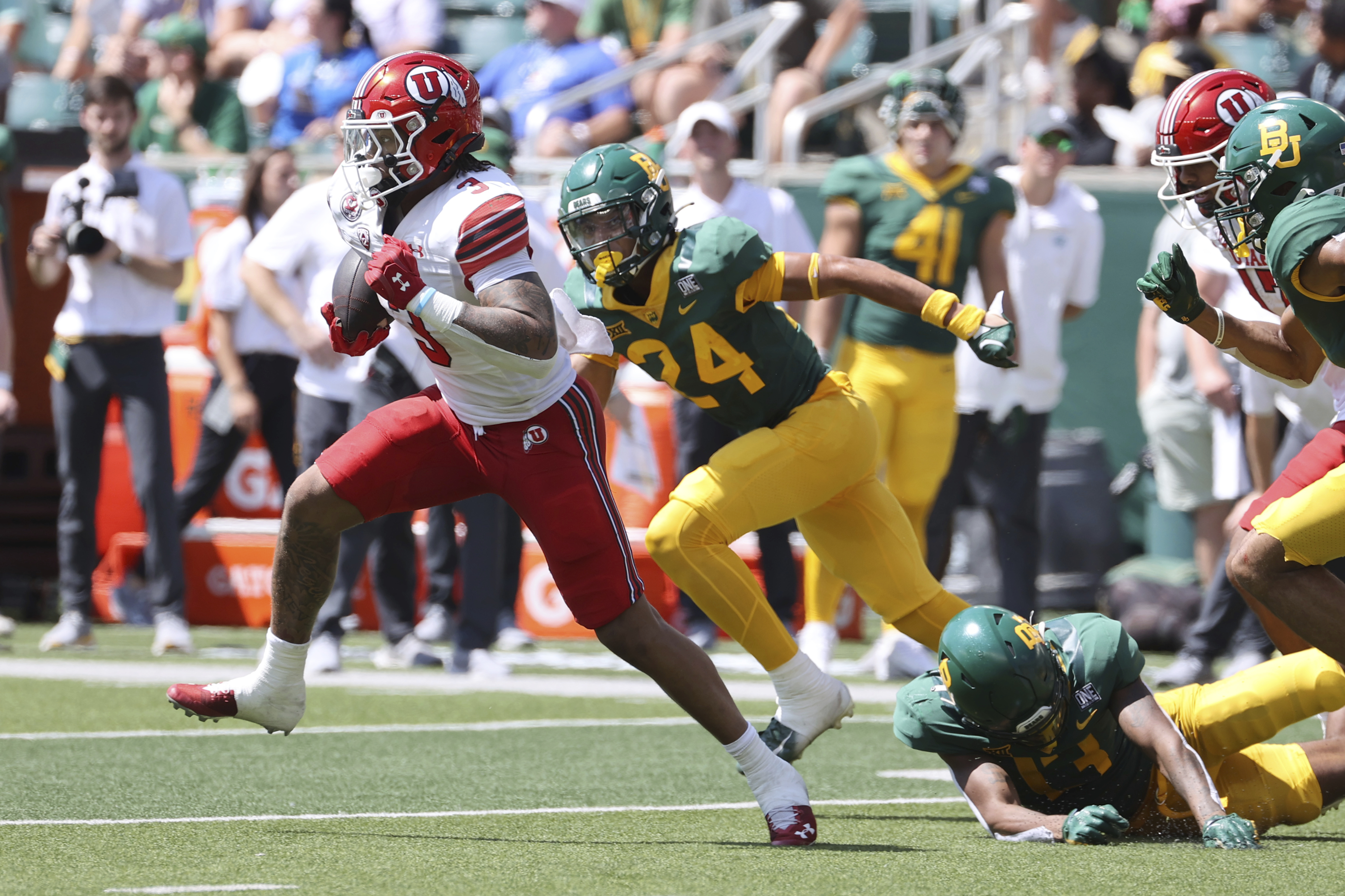 Utah running back Ja'Quinden Jackson (3) runs through the Baylor defense in the first half of an NCAA college football game, Saturday, Sept. 9, 2023, in Waco, Texas.