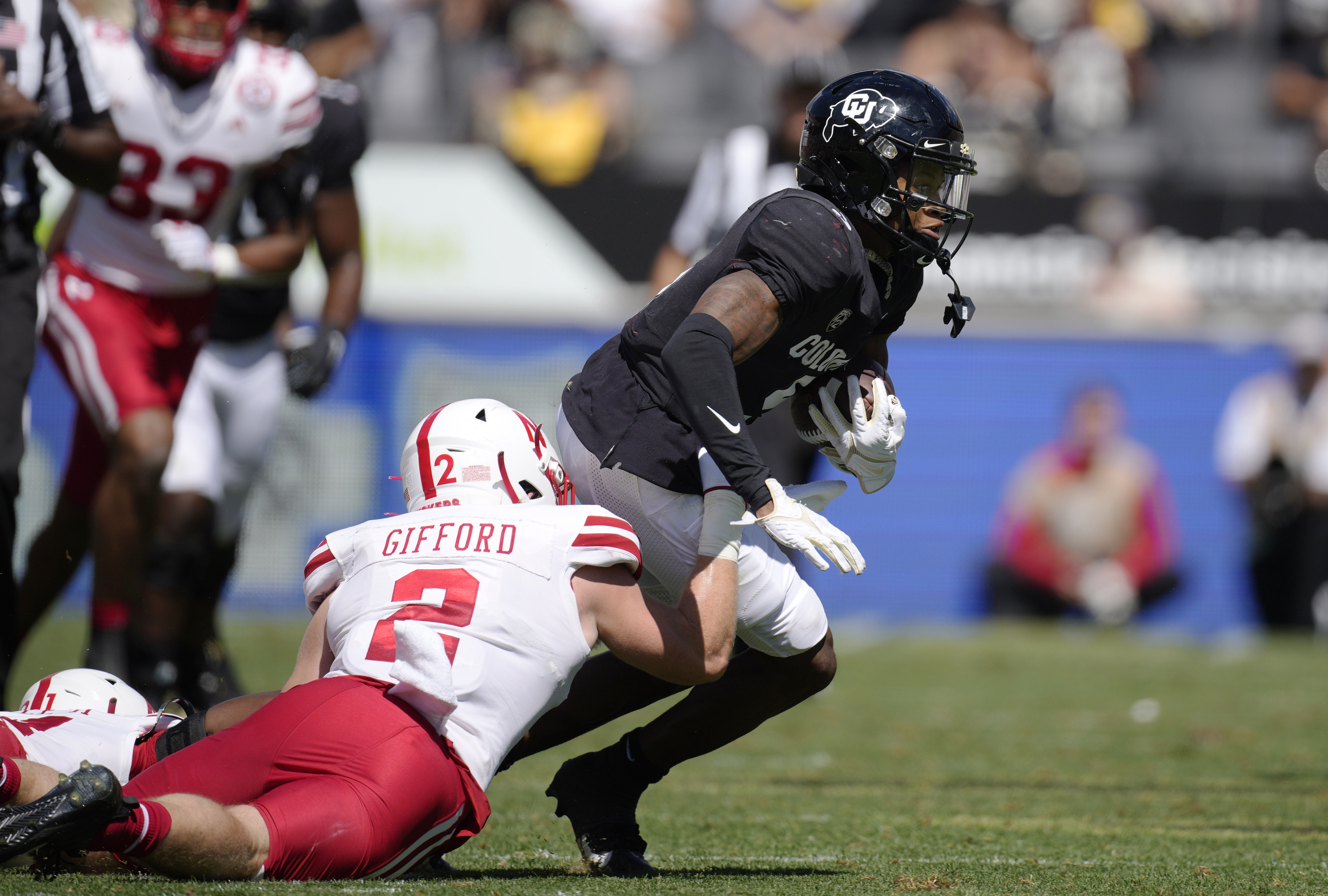 Nebraska defensive back Isaac Gifford, left, pulls down Colorado wide receiver Jimmy Horn Jr. after he caught a pass in the second half of an NCAA college football game Saturday, Sept. 9, 2023, in Boulder, Colo.