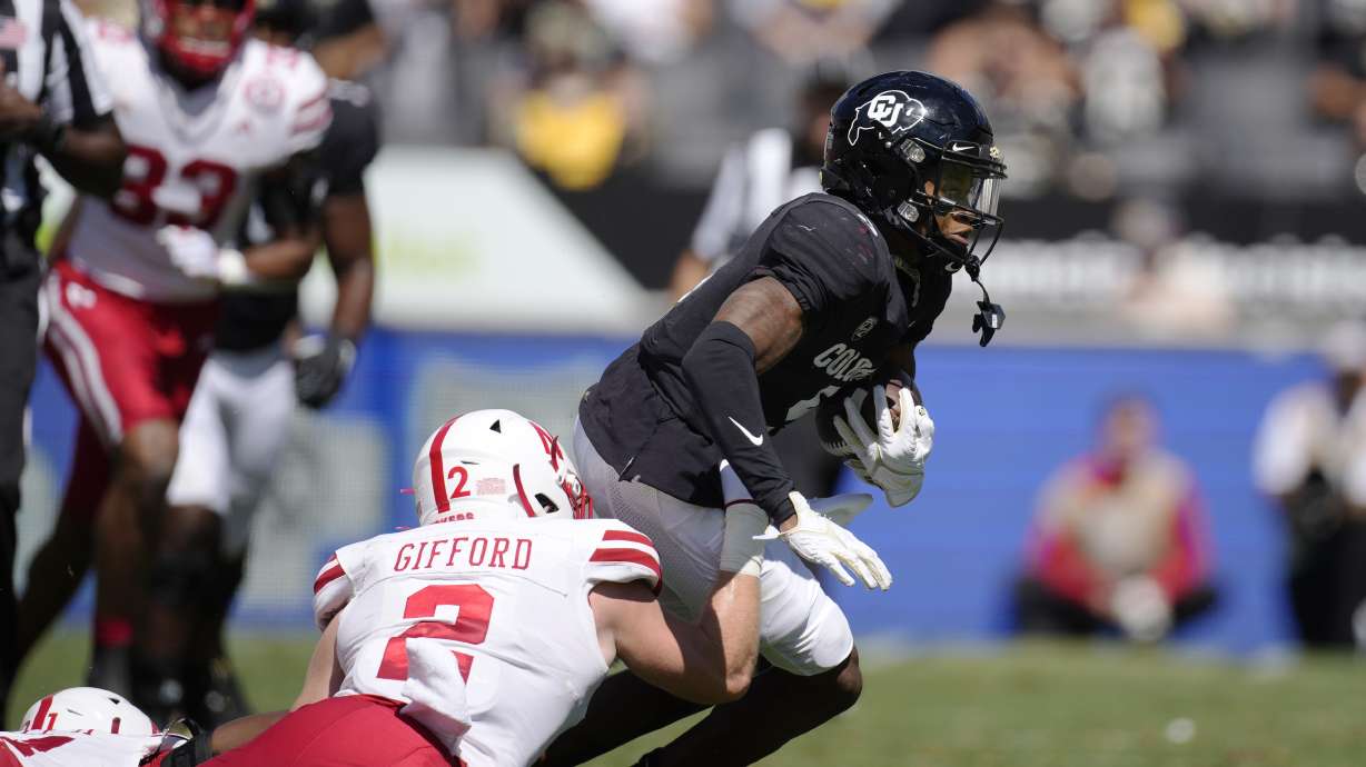 Nebraska defensive back Isaac Gifford, left, pulls down Colorado wide receiver Jimmy Horn Jr. after he caught a pass in the second half of an NCAA college football game Saturday, Sept. 9, 2023, in Boulder, Colo.