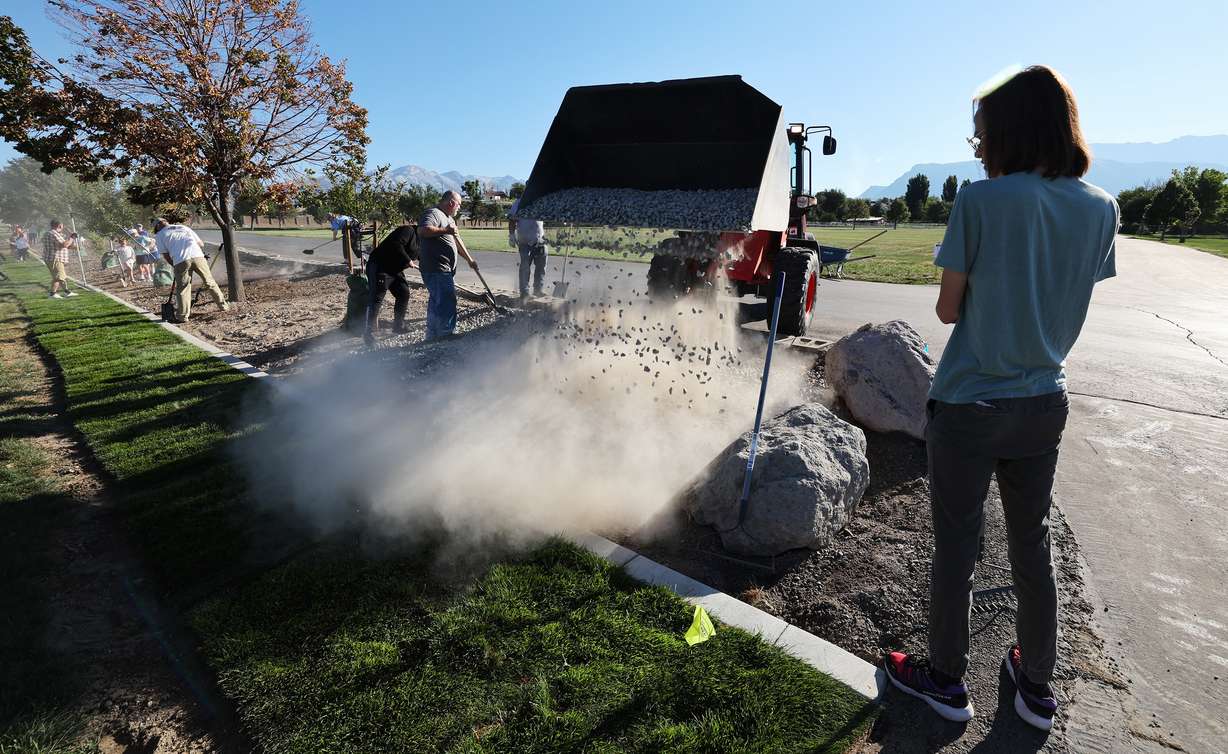 Gravel is dumped for volunteers to spread out as Lehi residents team up to perform service at the new soccer fields and city park on Saturday as part of the 9/11 Day of Service.