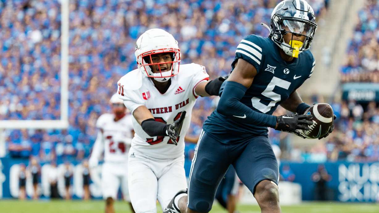 Brigham Young wide receiver Darius Lassiter (5) catches the ball with Southern Utah Thunderbirds cornerback Lacarea Pleasant-Johnson (31) on his tail at LaVell Edwards Stadium in Provo on Saturday, Sept. 9, 2023.