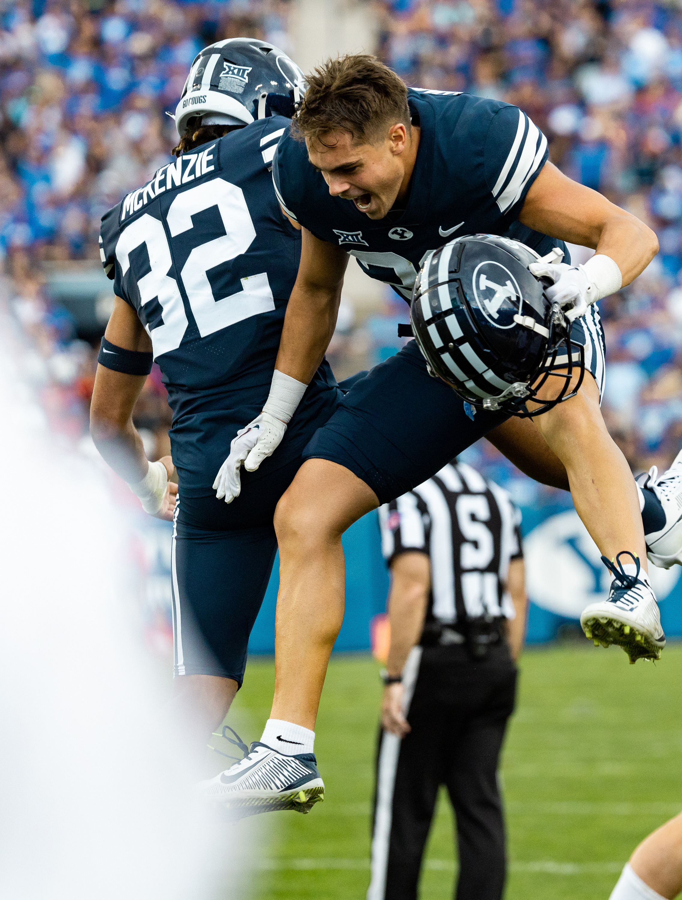 Brigham Young cornerback Marcus McKenzie (32) and safety Crew Wakley (38) celebrate an interception during an NCAA football game against the Southern Utah Thunderbirds at LaVell Edwards Stadium in Provo on Saturday, Sept. 9, 2023. BYU won the game 41-16.