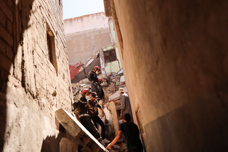 Emergency workers search a destroyed building, in the aftermath of a deadly earthquake, in Amizmiz, Morocco, on Sunday.