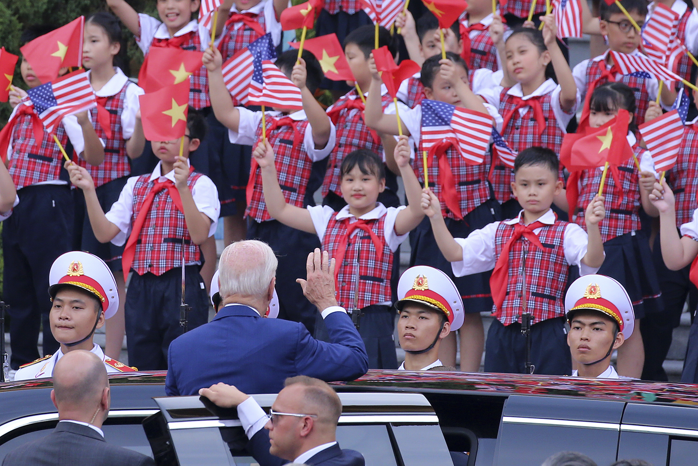 US President Joe Biden waves to the children after a military welcome ceremony at the Presidential Palace in Hanoi, Vietnam, Sunday. Biden is on an official two-day visit in Vietnam.