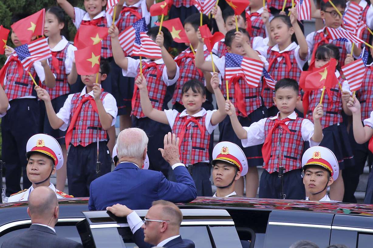 US President Joe Biden waves to the children after a military welcome ceremony at the Presidential Palace in Hanoi, Vietnam, Sunday. Biden is on an official two-day visit in Vietnam.