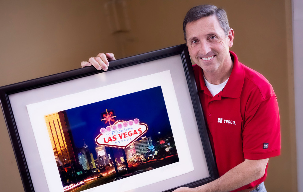 Jeffrey Young, executive vice president at YESCO, holds a photograph of the “Welcome to Fabulous Las Vegas” sign that his company owns at YESCO in Salt Lake City on Aug. 30.