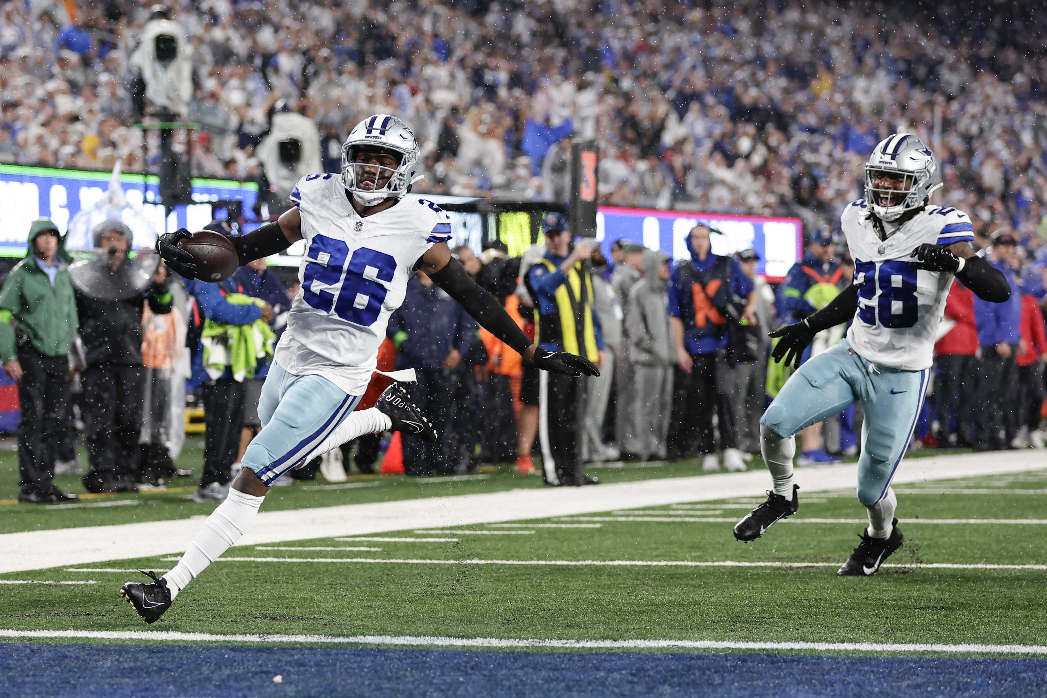 Dallas Cowboys' DaRon Bland, left, reacts as he scores after intercepting the pass intended for New York Giants' Saquon Barkley during the first half of an NFL football game, Sunday, Sept. 10, 2023, in East Rutherford, N.J.