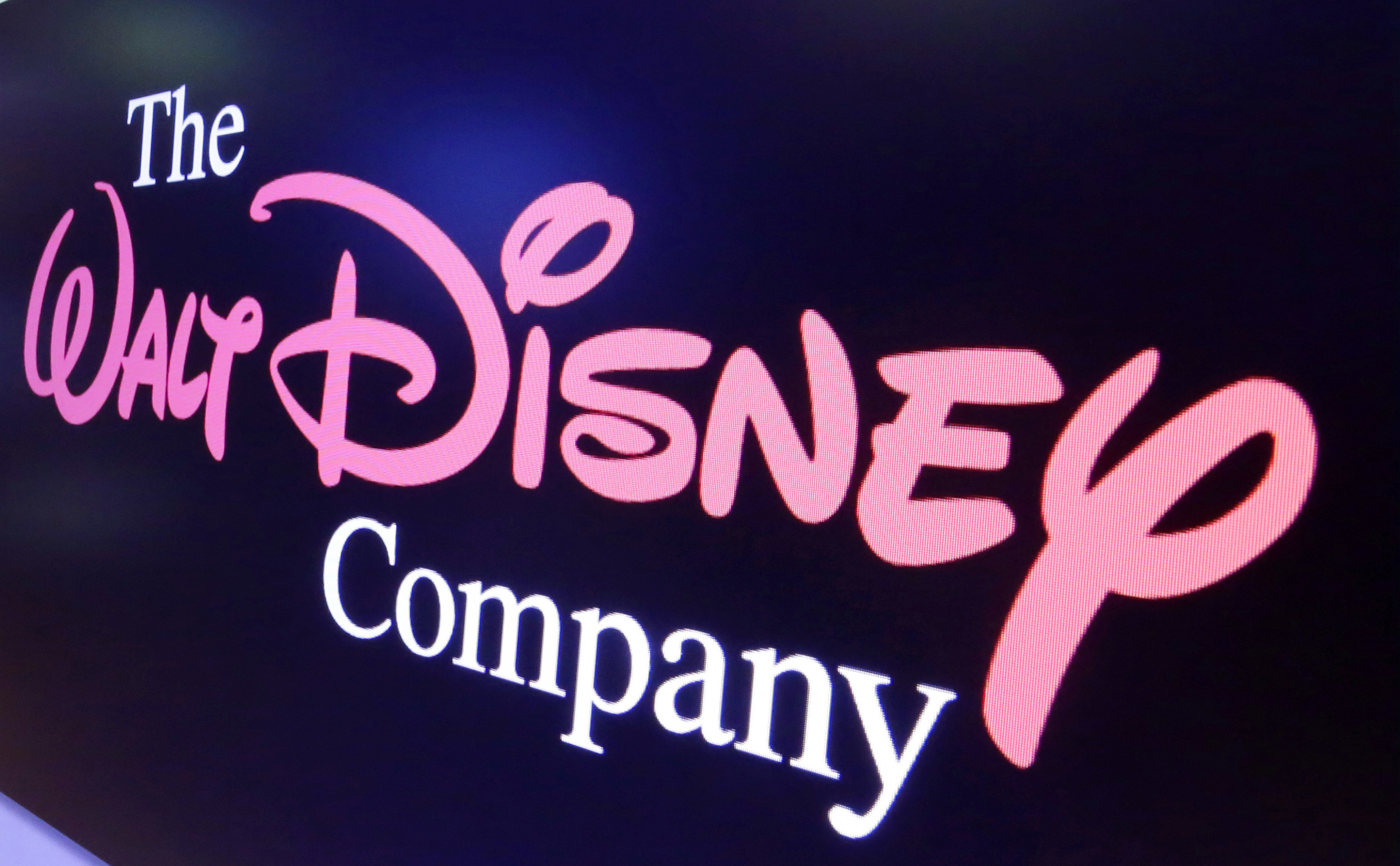 FILE - The Walt Disney Co. logo appears on a screen above the floor of the New York Stock Exchange, Aug. 7, 2017, in New York. The company representing nearly 15 million cable subscribers and the Walt Disney Co. blamed each other Friday, Sept. 1, 2023 in a business dispute that cut off Disney-owned stations to customers on the eve of a big sports weekend for U.S. Open tennis and college football fans. 