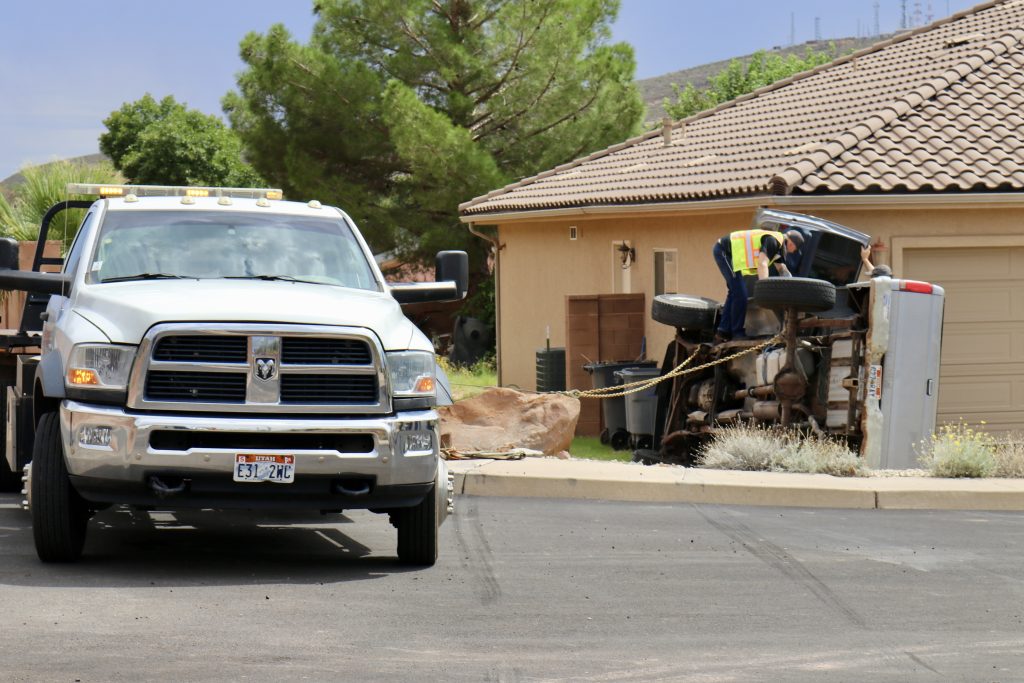 A truck is seen on its side after it crashes into a home in St. George on Sunday.