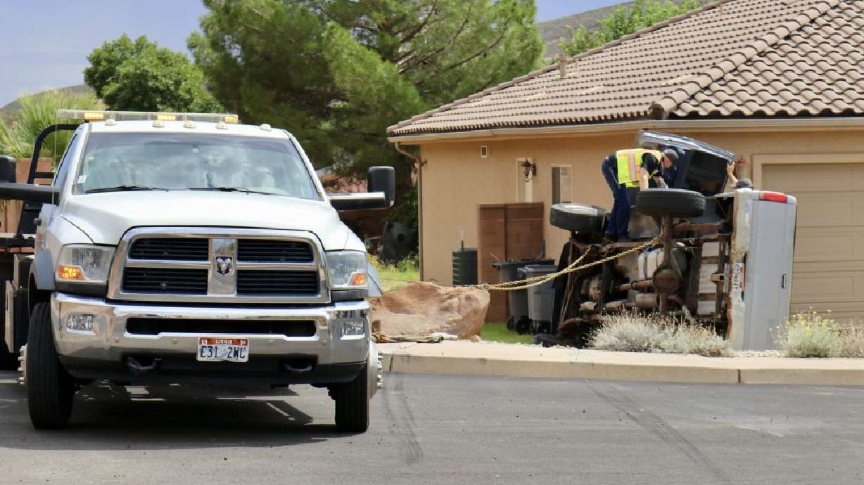 A truck is seen on its side after it crashes into a home in St. George on Sunday.