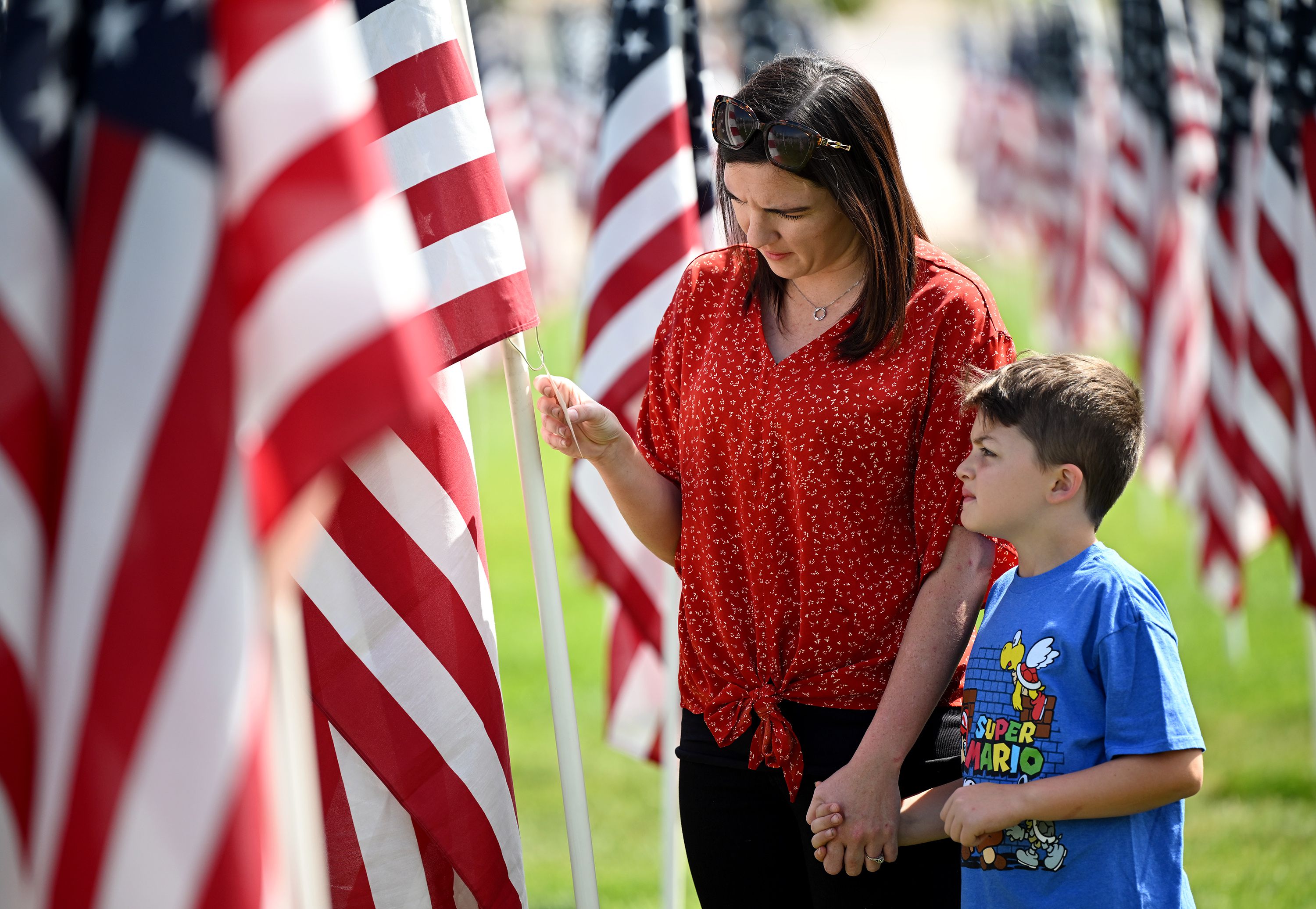Shalaya Mullins and her son Braxton look around the Sandy 9/11 Healing Field on Sunday.