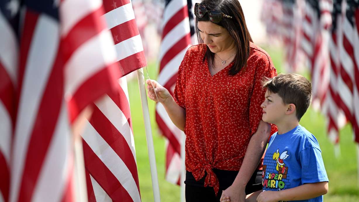 Shalaya Mullins and her son Braxton look around the Sandy 9/11 Healing Field on Sunday.