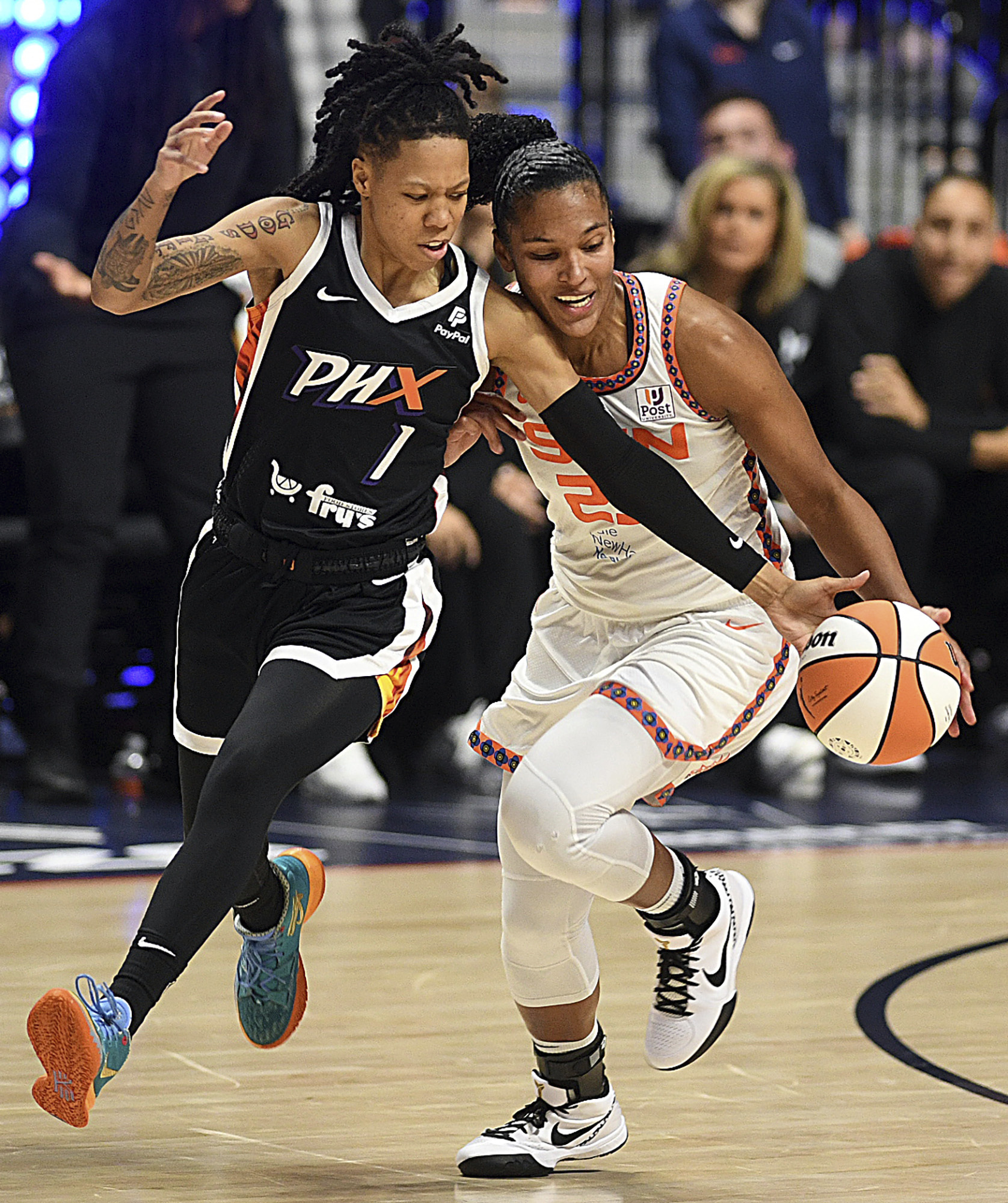 Phoenix Mercury's Sug Sutton (1) steals a ball from Connecticut Sun's Alyssa Thomas (25) during a WNBA basketball game in Uncasville, Conn., Thursday, Aug. 31, 2023. 