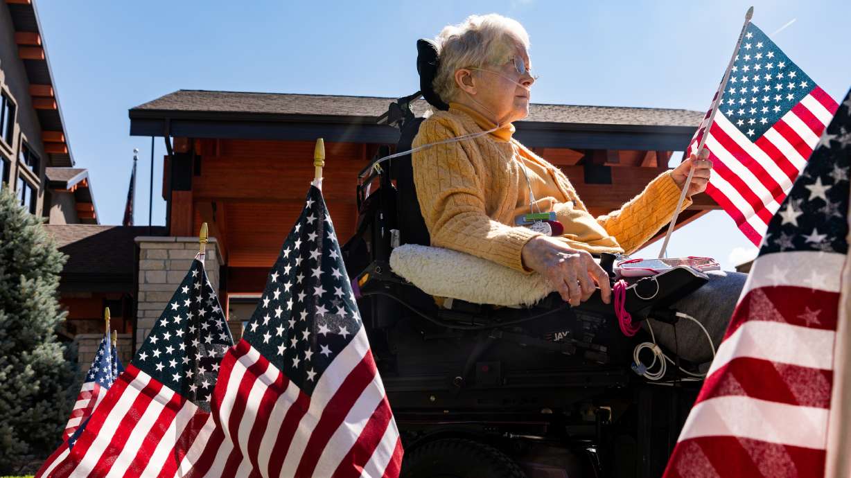 Ruth Powell waits to place her flag at a 9/11 memorial tribute at Copper Creek Senior Living in South Jordan on Monday. Every resident was invited to put up a flag and share with caretakers where they were on 9/11.