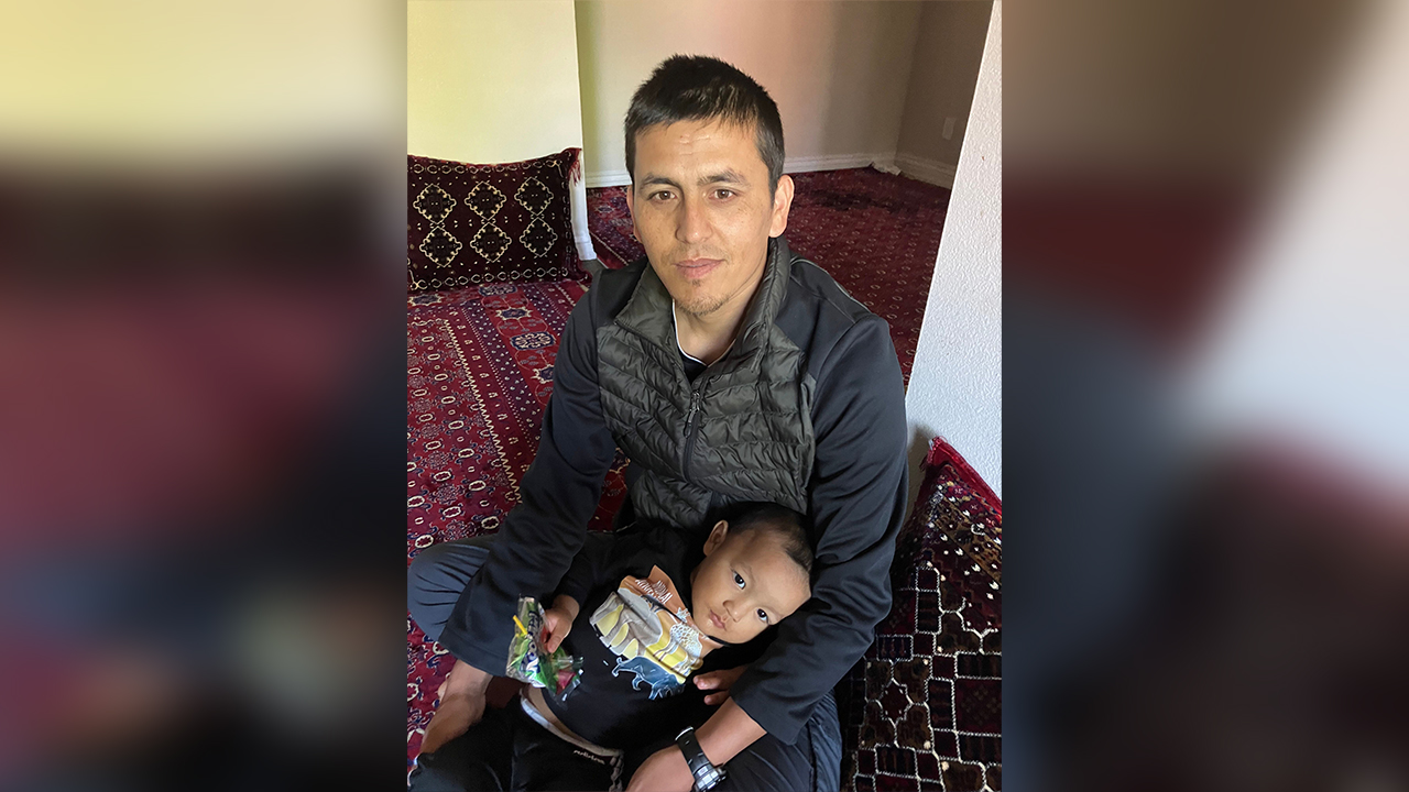 Zero Unit veteran Arif Haidari holds his son at their apartment May 11, in West Valley City, where he received an eviction notice because he was not able to pay the previous month’s rent.