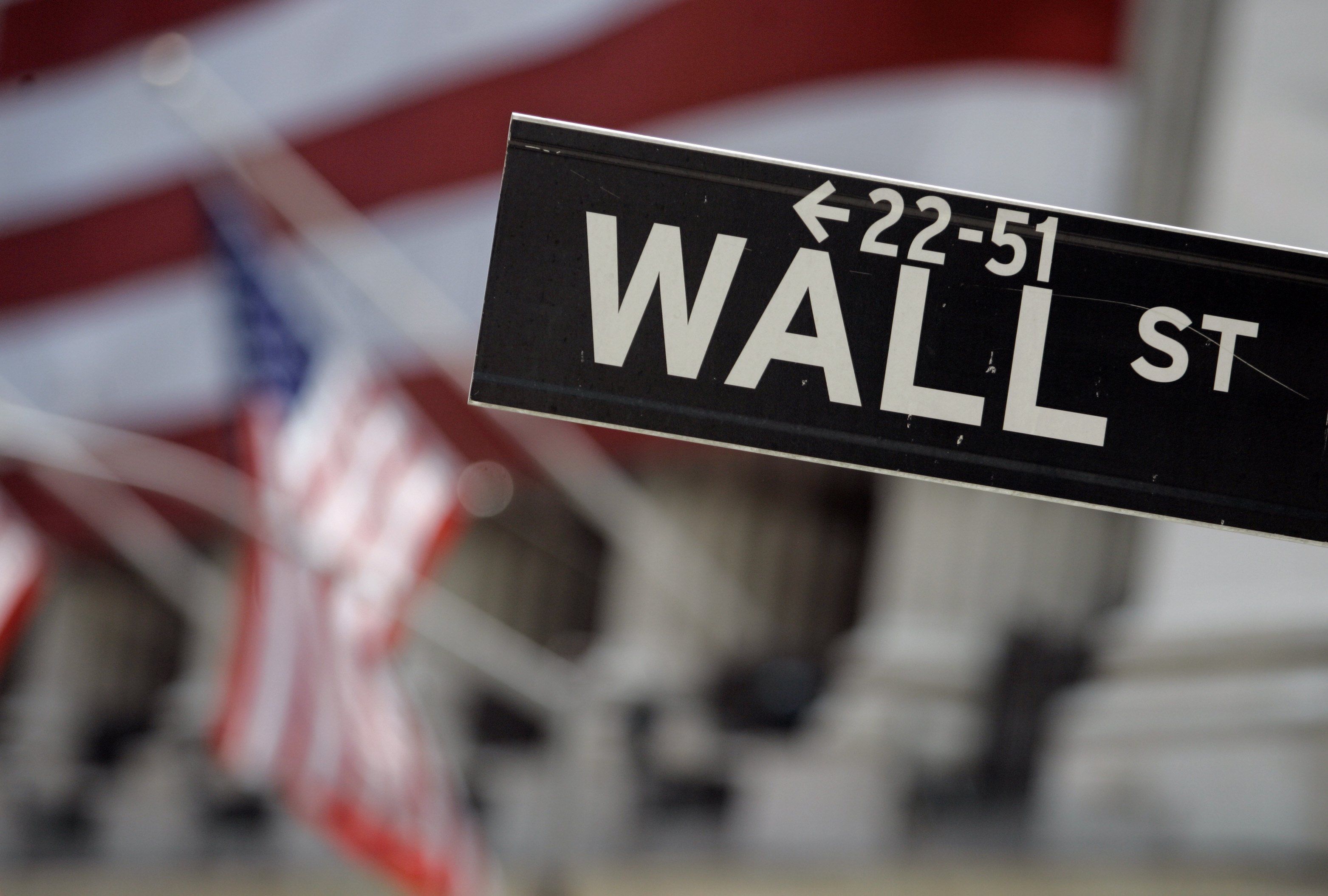 A Wall Street sign is seen in front of the flag-draped facade of the New York Stock Exchange May 11, 2007. The Beehive State is launching a new program to help students from elementary to high school gain more stock market savvy.