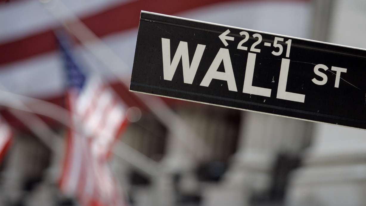 A Wall Street sign is seen in front of the flag-draped facade of the New York Stock Exchange May 11, 2007. The Beehive State is launching a new program to help students from elementary to high school gain more stock market savvy.